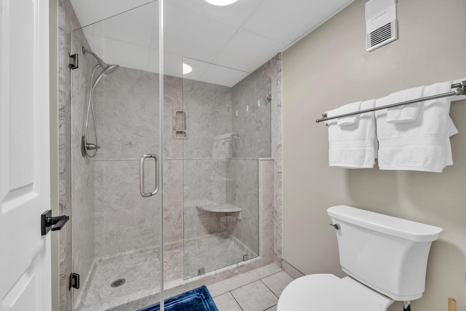 Master walk in shower w/ hand held wand and seat