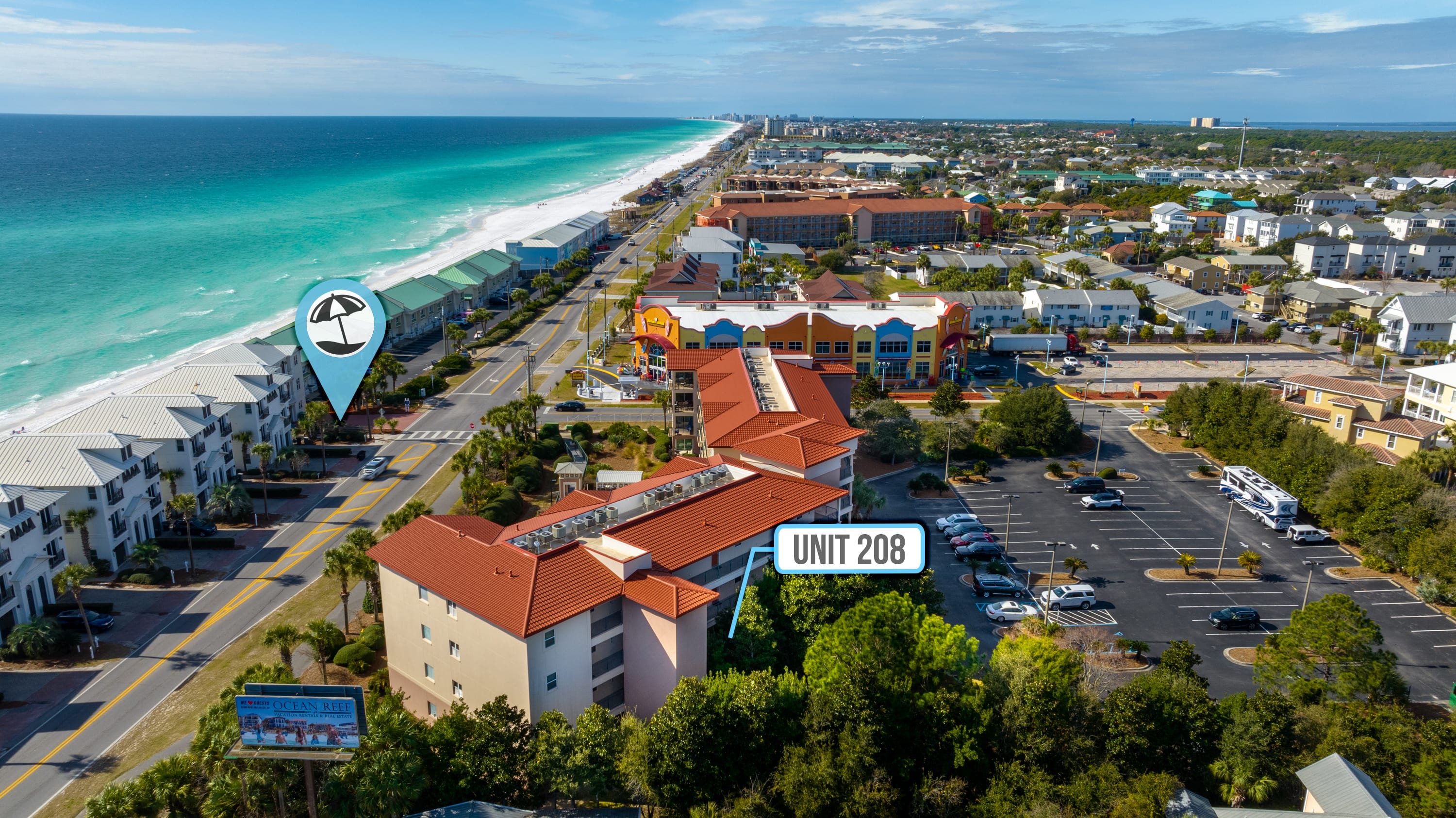 The beach entrance is marked here. It is accessed with a short walk through the pool area and across the street. 