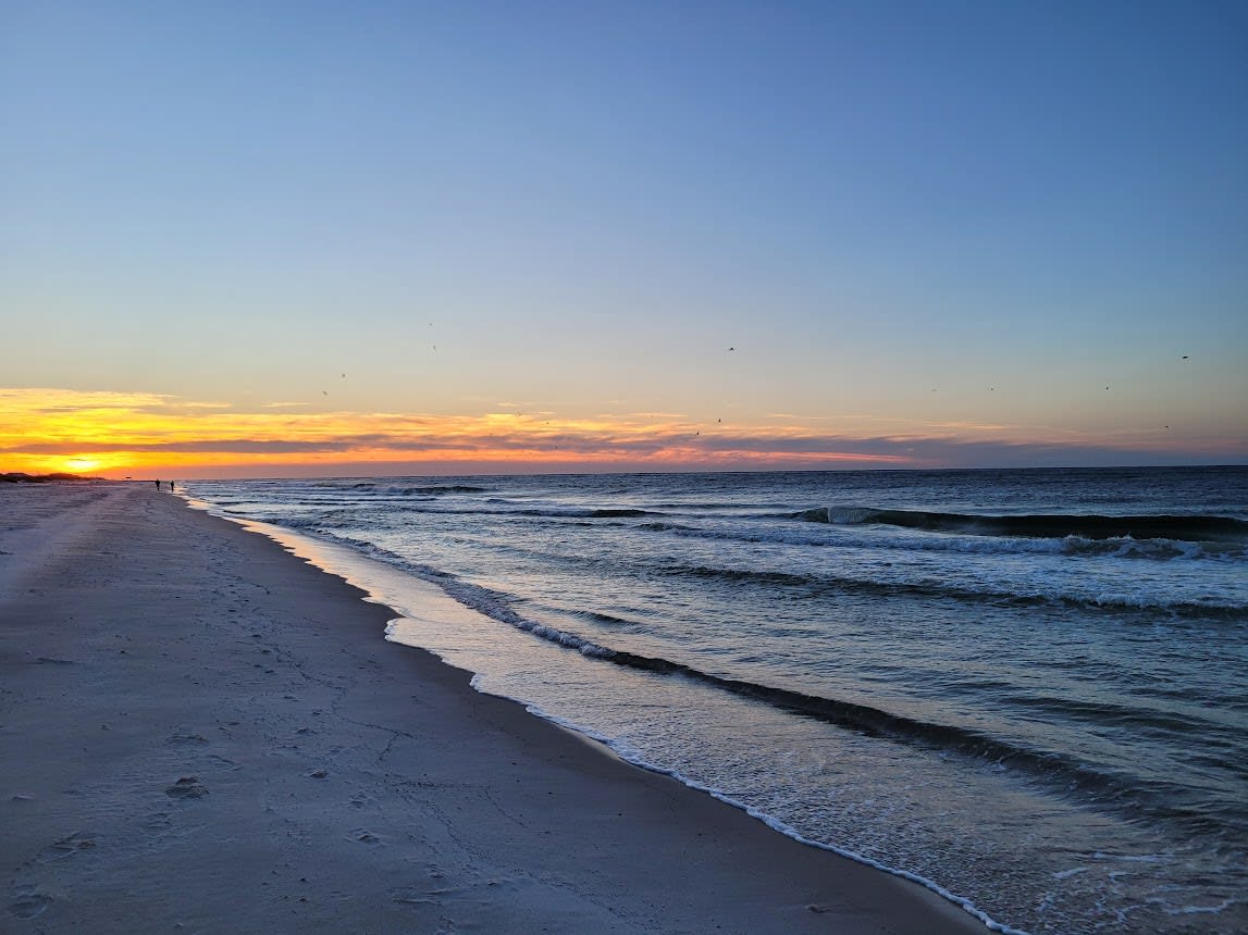 Enjoy the sunrise while listening to the sound of the waves while walking on the white sands of bama