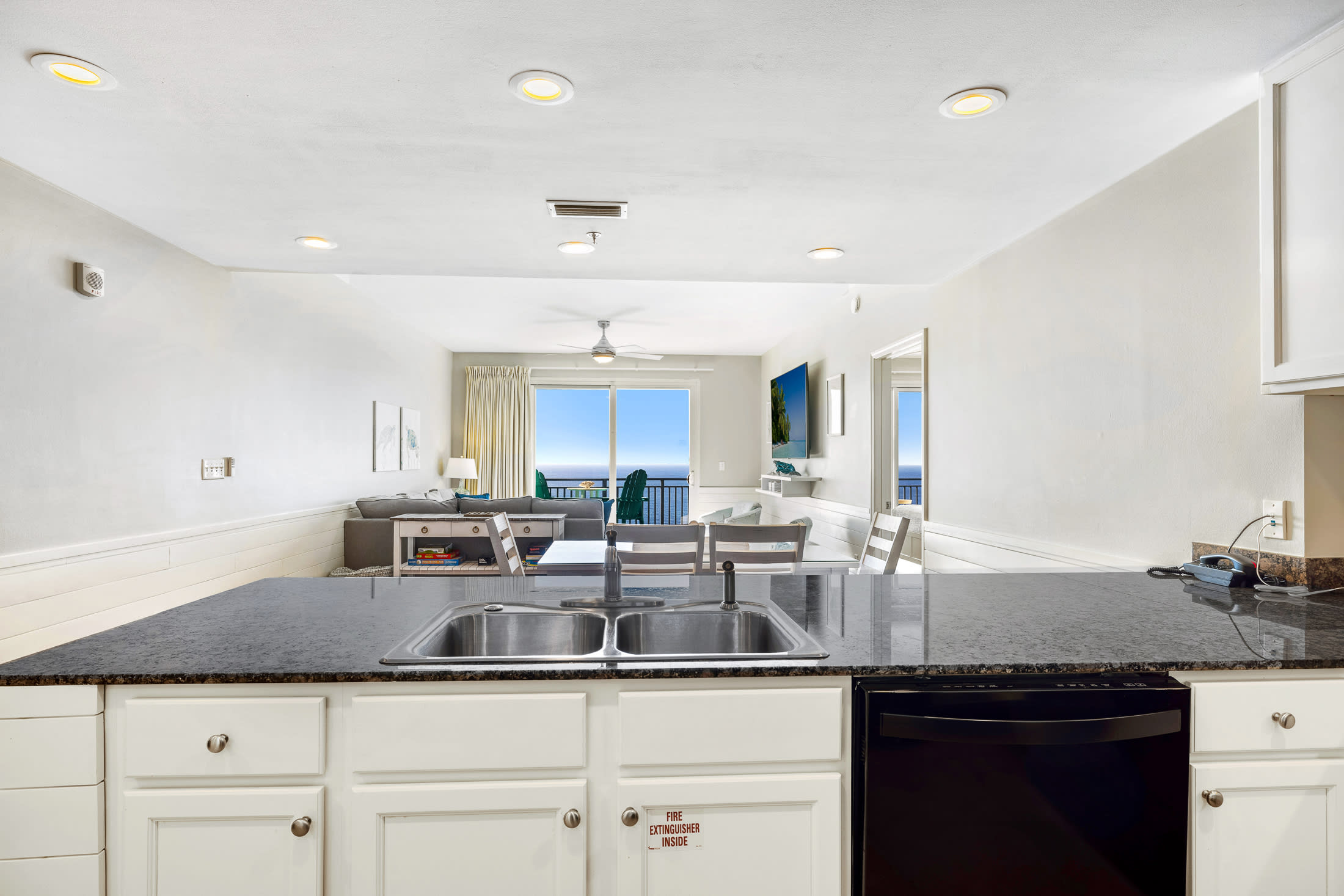 The open concept kitchen, dining and living room is perfect for spending time together as a family.  Bonus - your significant other can watch the waves as they do the dishes!