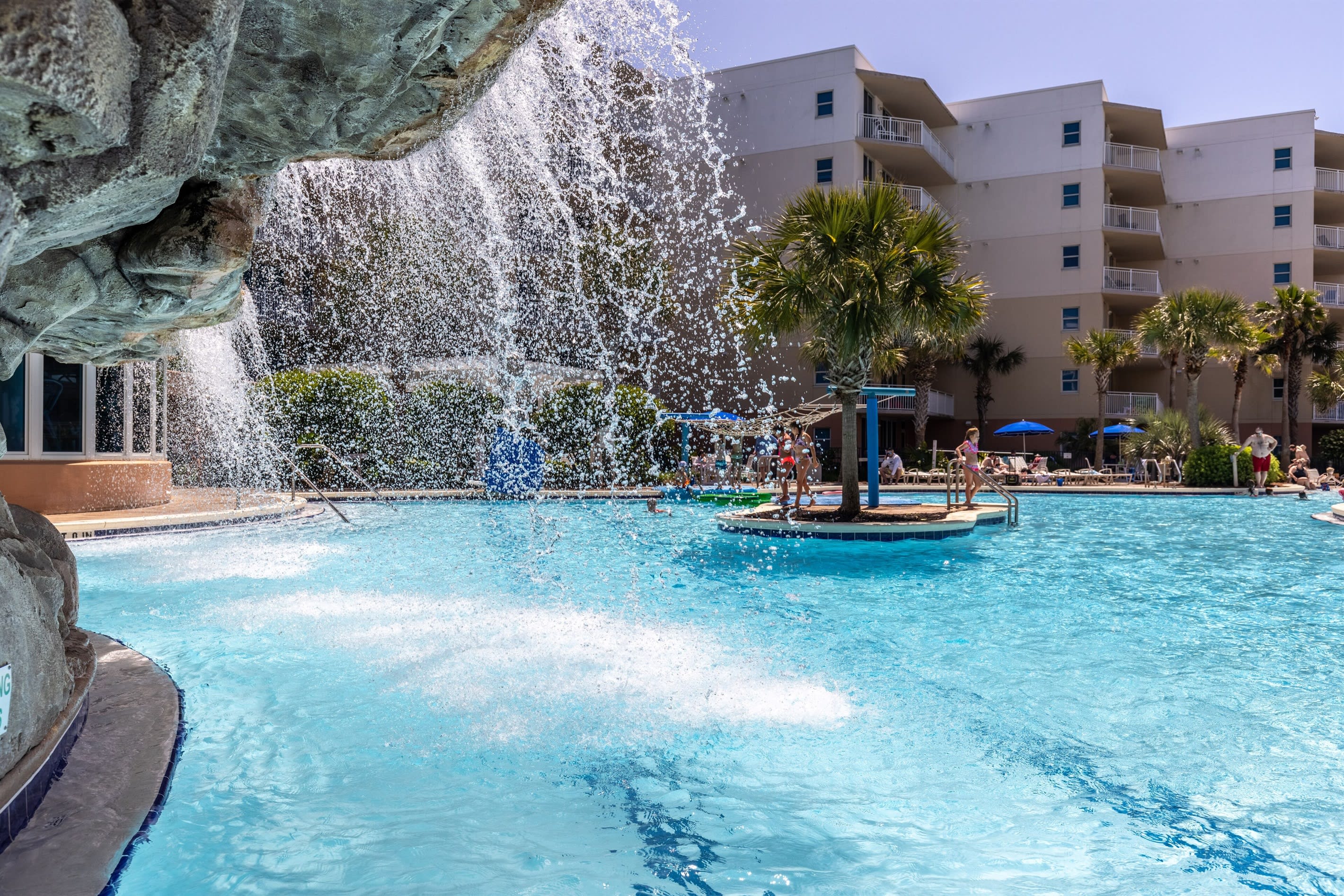 Relax under the waterfall feature in the lower pool on hot days. 