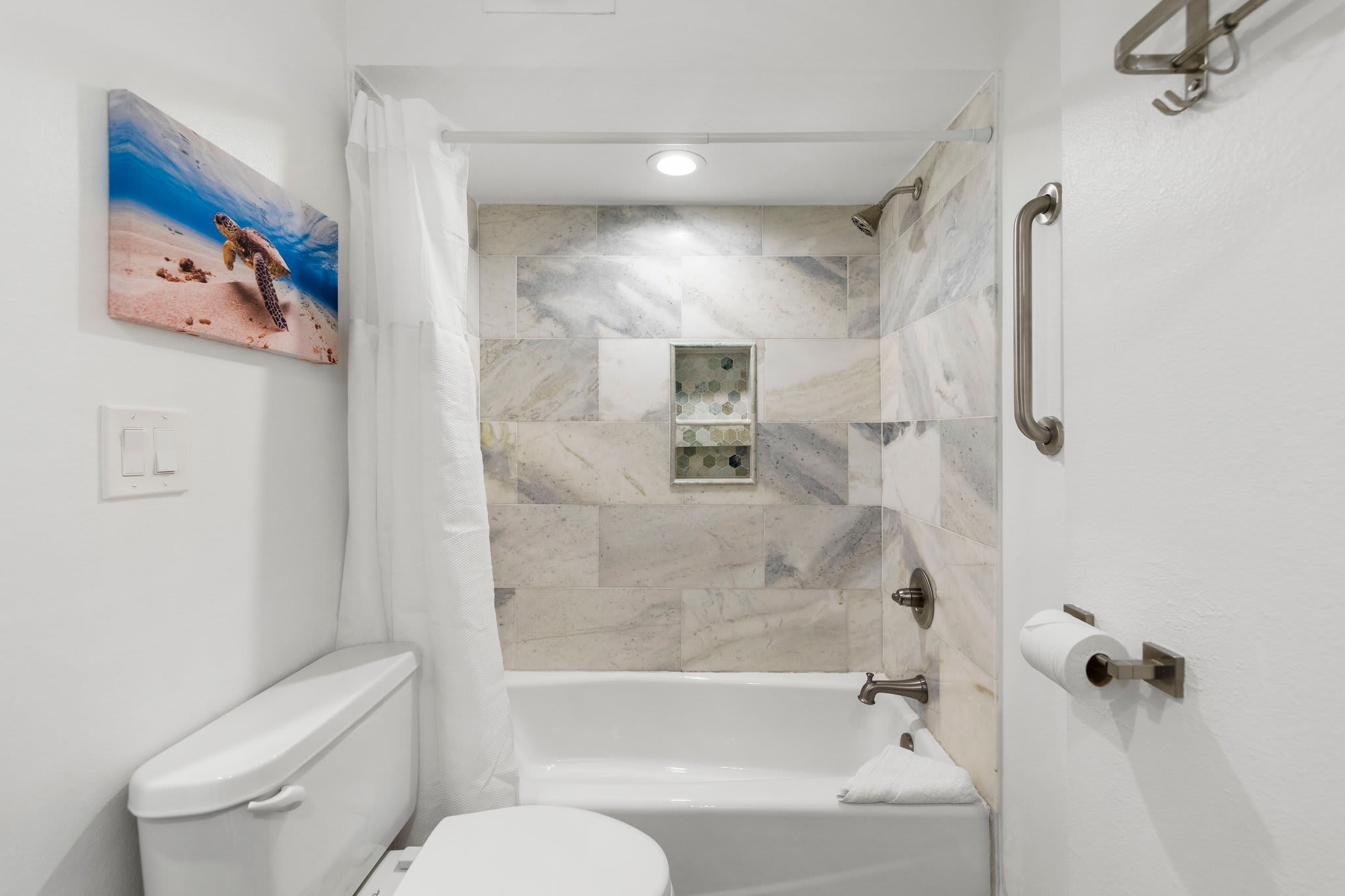 Gorgeous tile in the primary en-suite bathroom. Bath/Shower combo