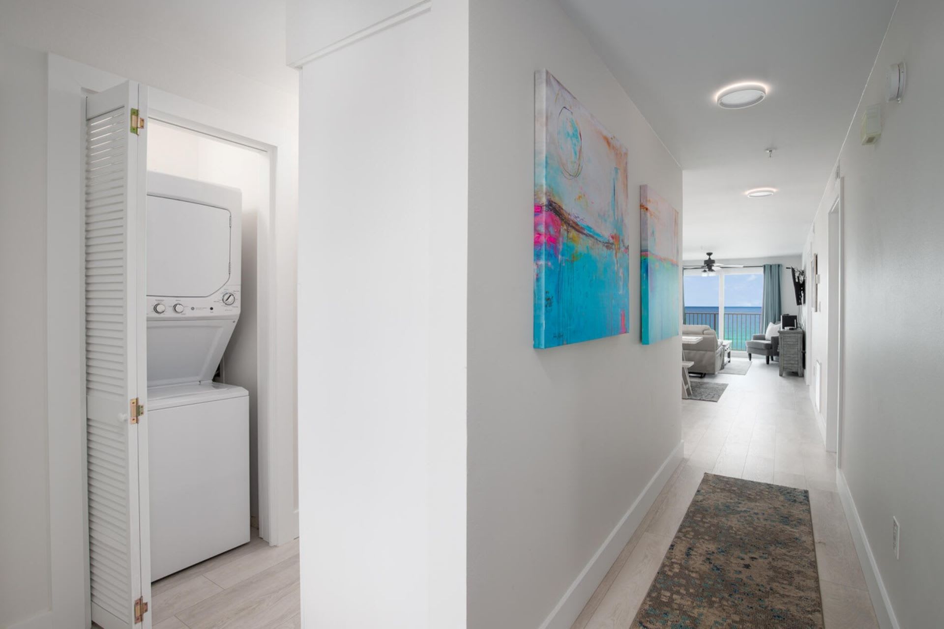 "Welcome to your home away from home! This bright and welcoming entrance also features a convenient in-unit washer and dryer, ensuring your stay is as comfortable and hassle-free as possible. ???? #VacationConvenience #BeachfrontLiving"