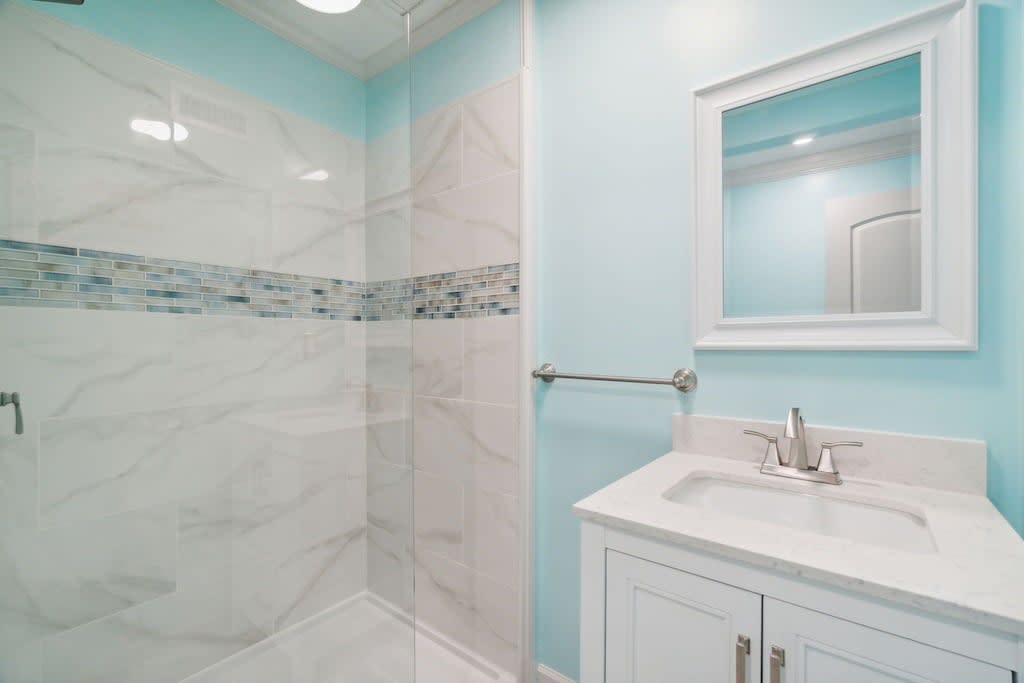 Right outside the queen bedroom, a full bathroom with a walk in shower.