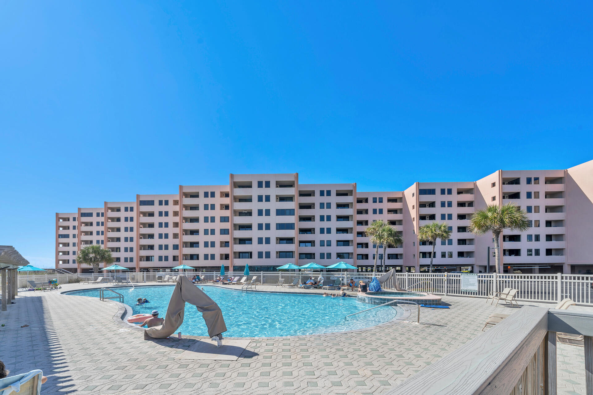 Expansive pool area set between the condos for sunny afternoons.