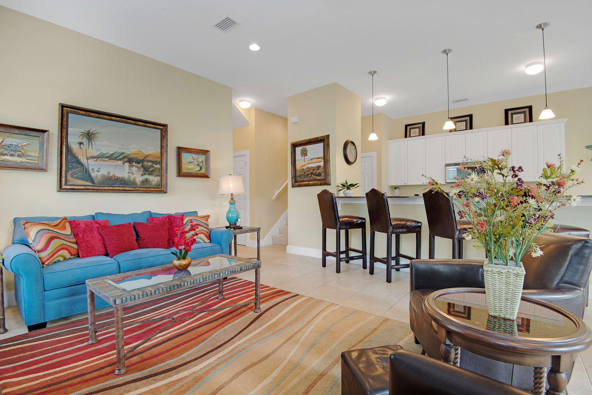 Bright and cheery living room has queen sofa sleeper for additional guest