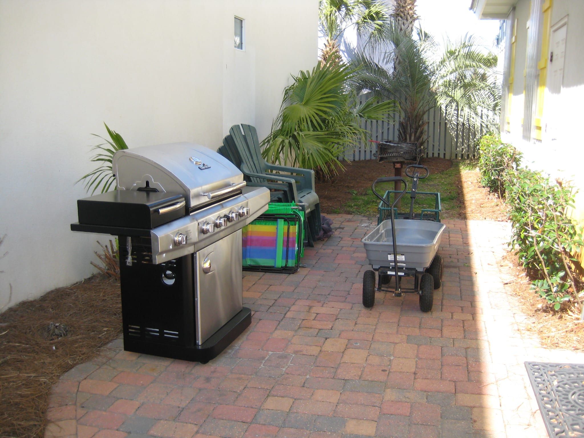 Gas grill, two beach wagons for ice chests and toys. Picnic table -- not shown