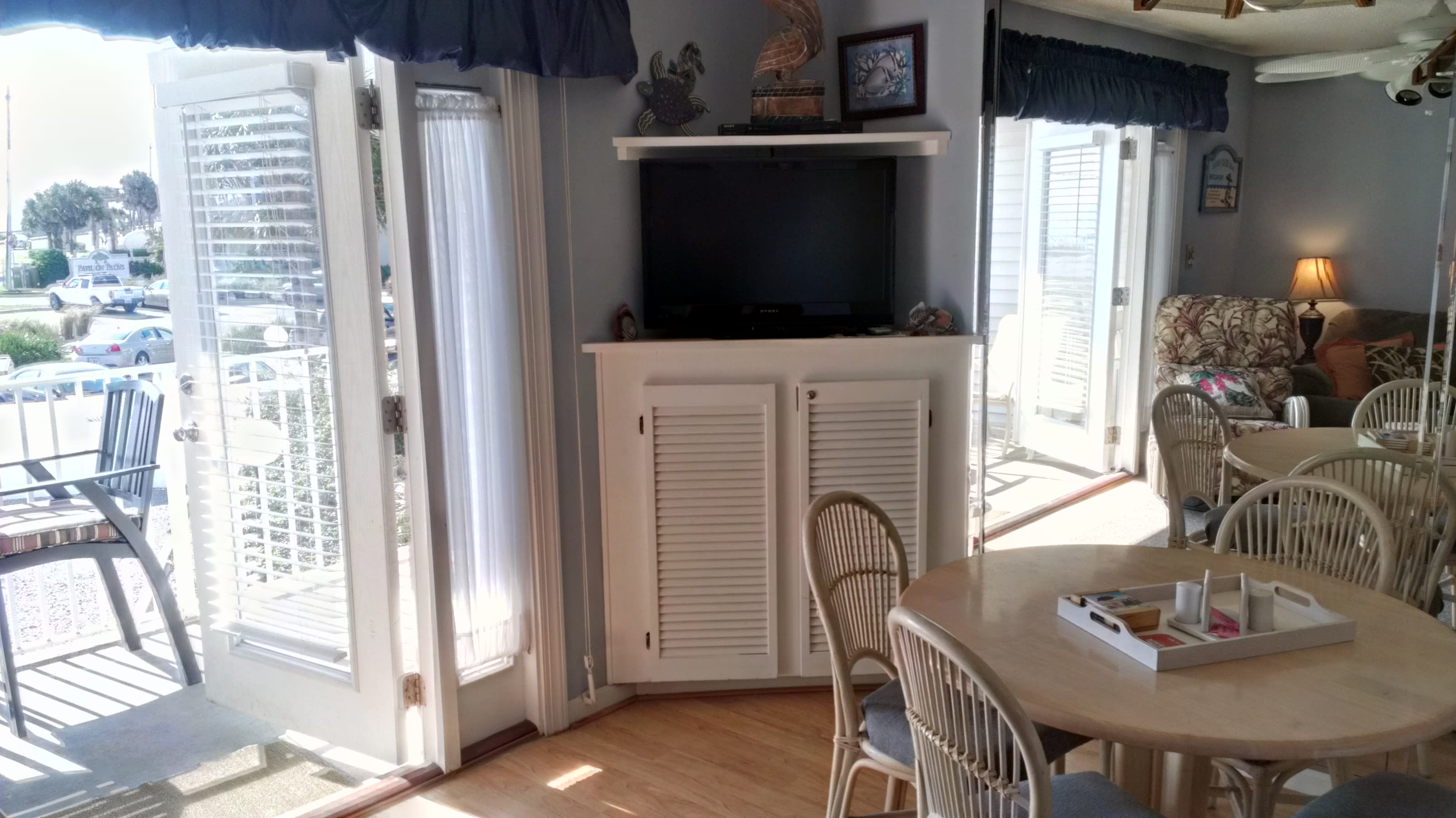 French doors open to a view of the Gulf and the hot tub/pool area.