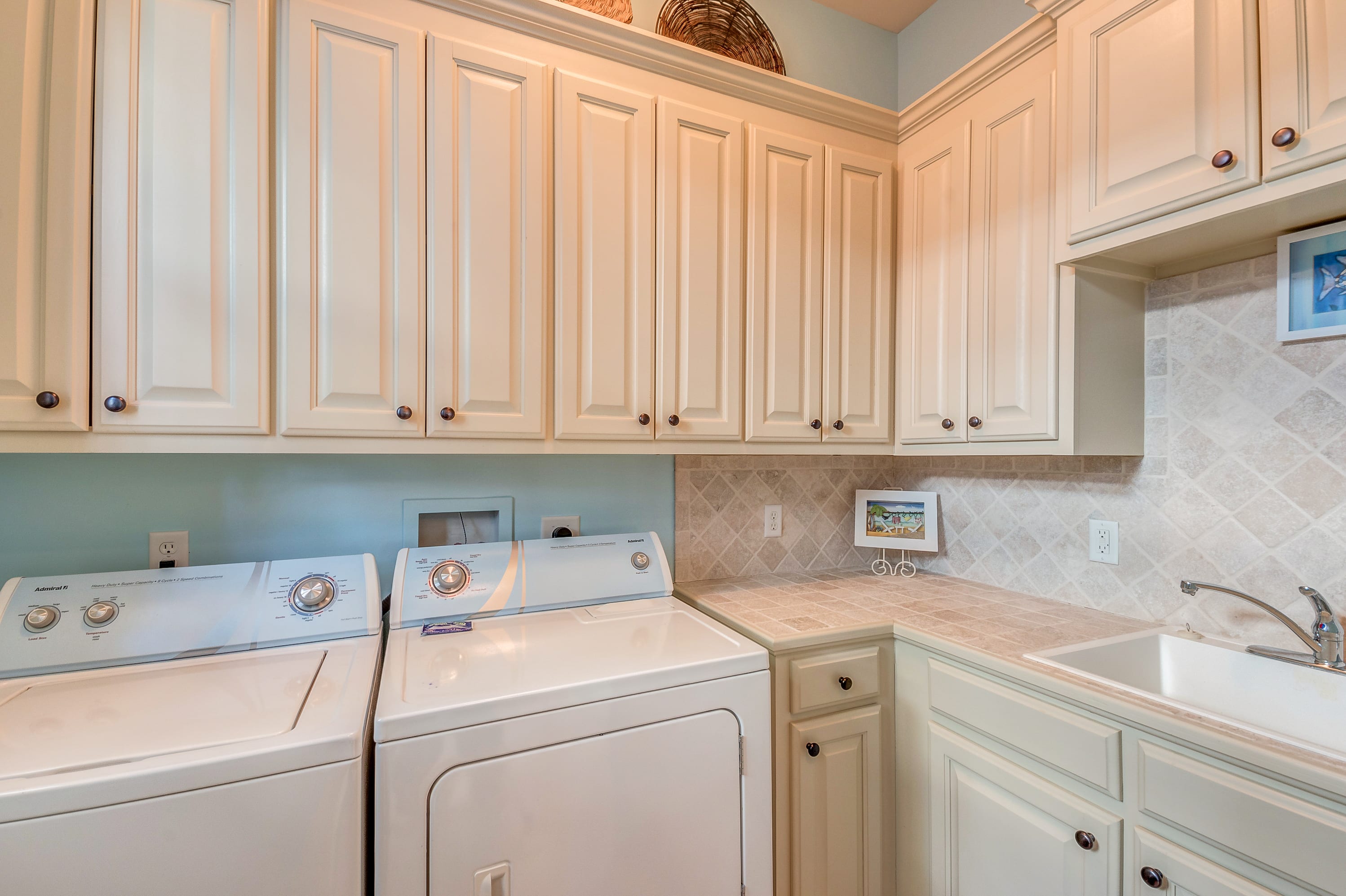 Large laundry room off of kitchen and door to outdoor shower station
