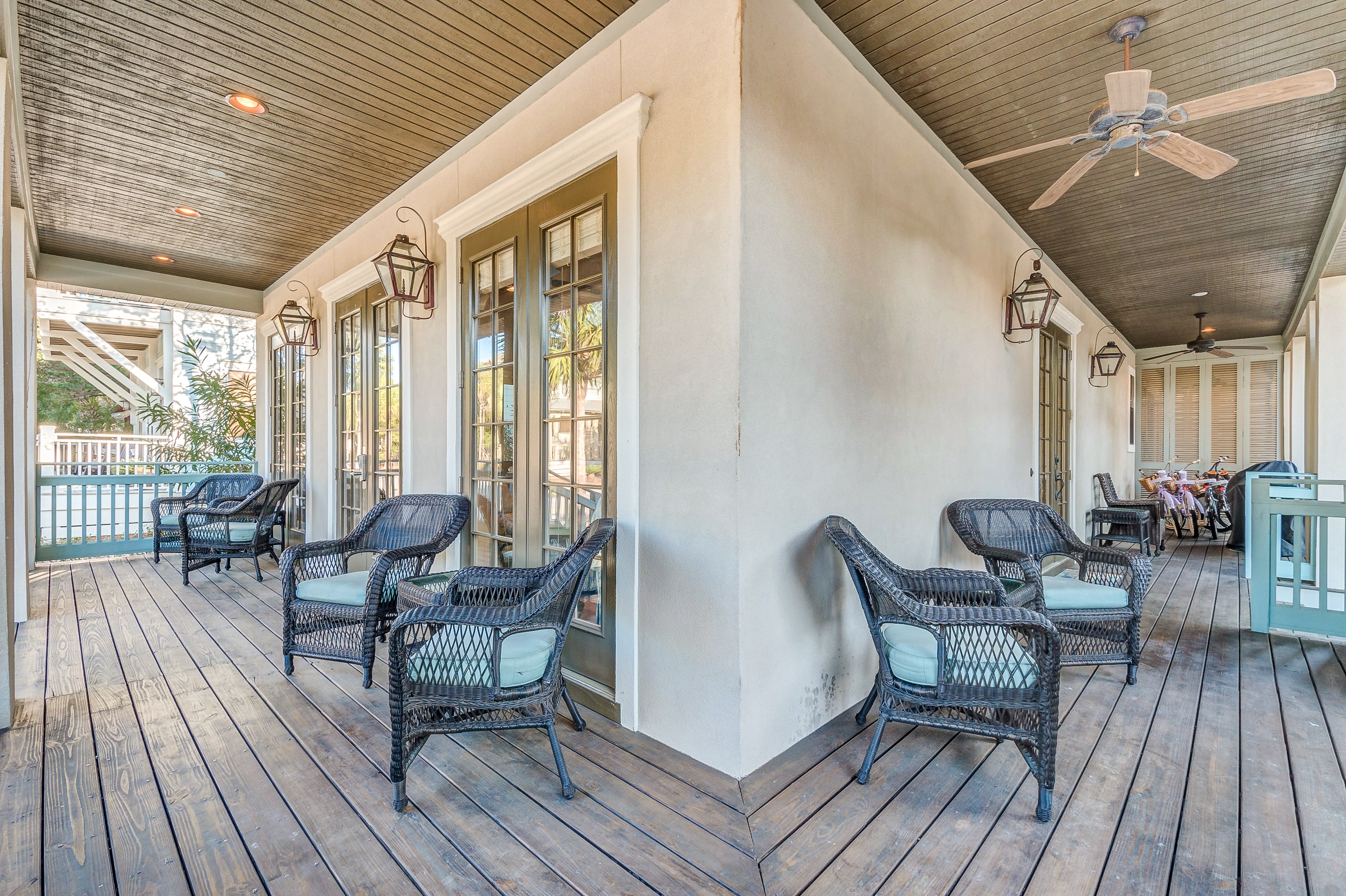 Large covered wrap around first floor porches with plenty of seating, old world gas lantern sconces, ceiling fans, gas grill, 4 bikes, beach toys, beach chairs