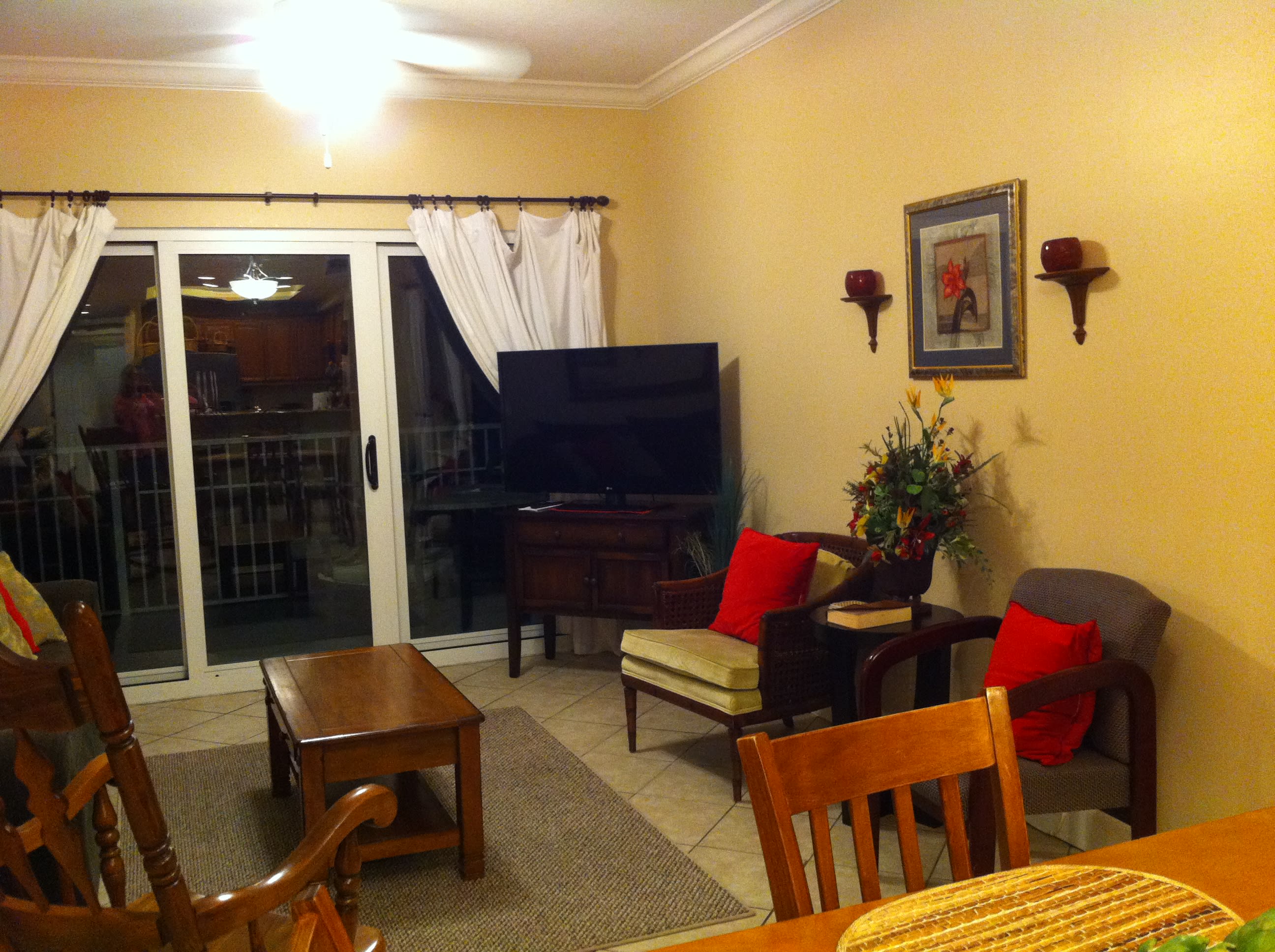 The living room features plenty of seating and a flat screen TV with a DVD library