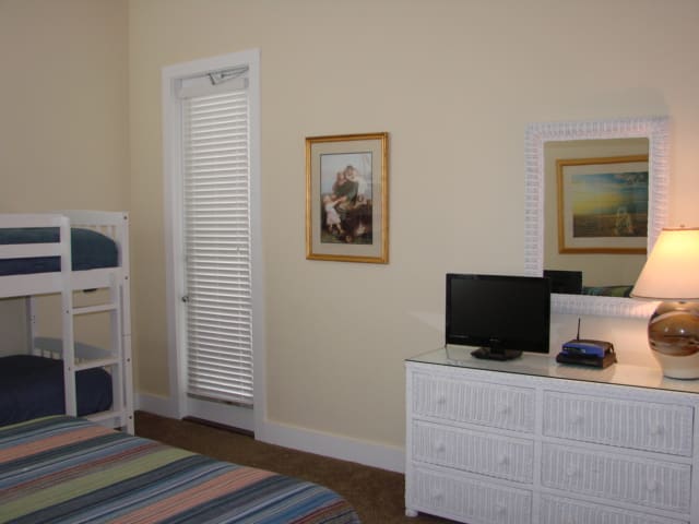 first floor guest bedroom features attached bath and flat screen tv