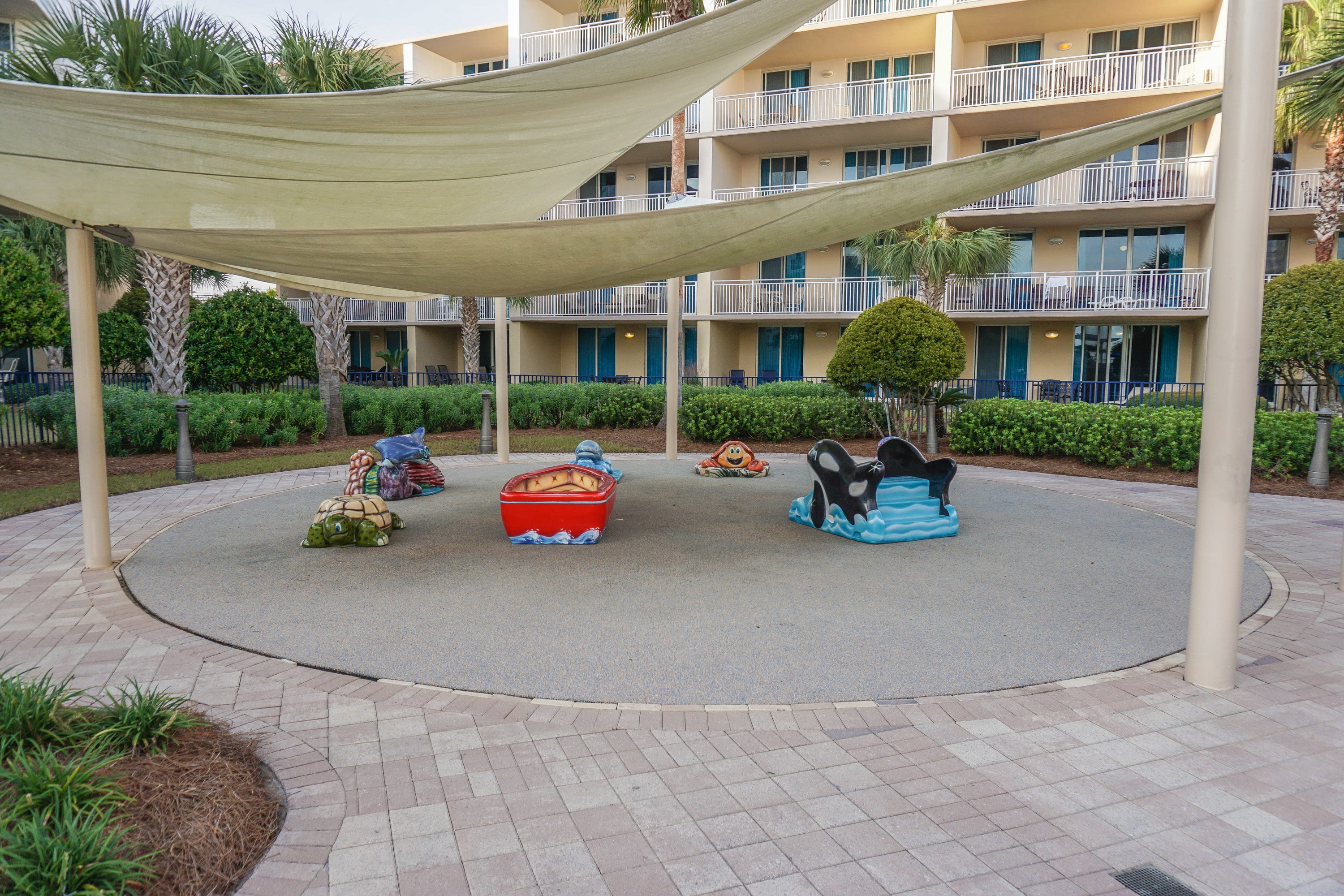 Rubber mat play area that is shaded. 