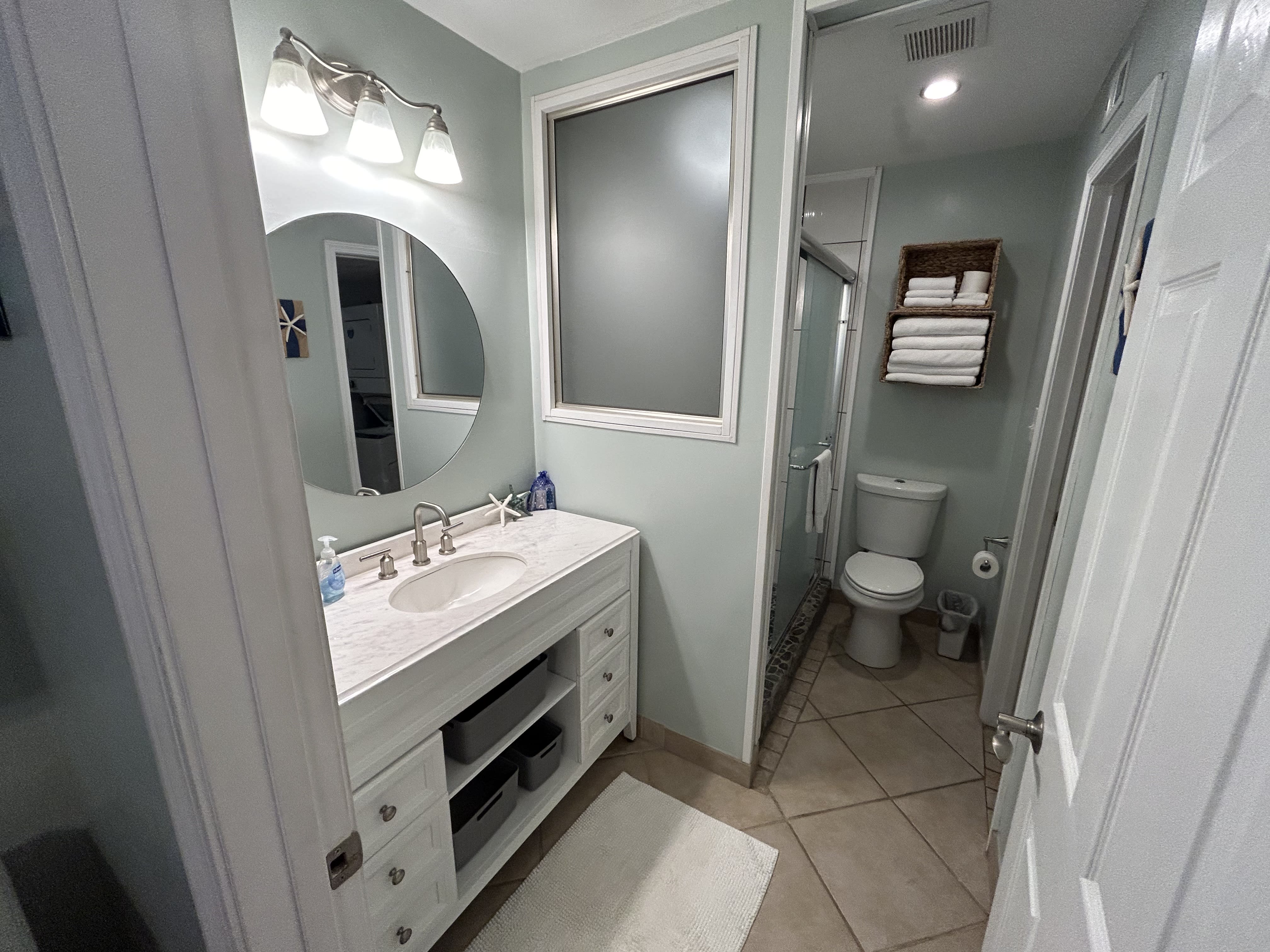 Refreshed bathroom with nice walk-in shower and quality linens