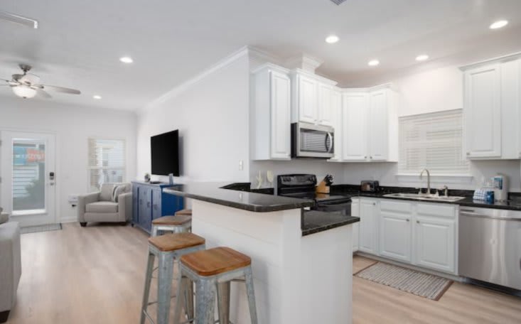 Fully equipped kitchen with granite counters and new french door fridge.