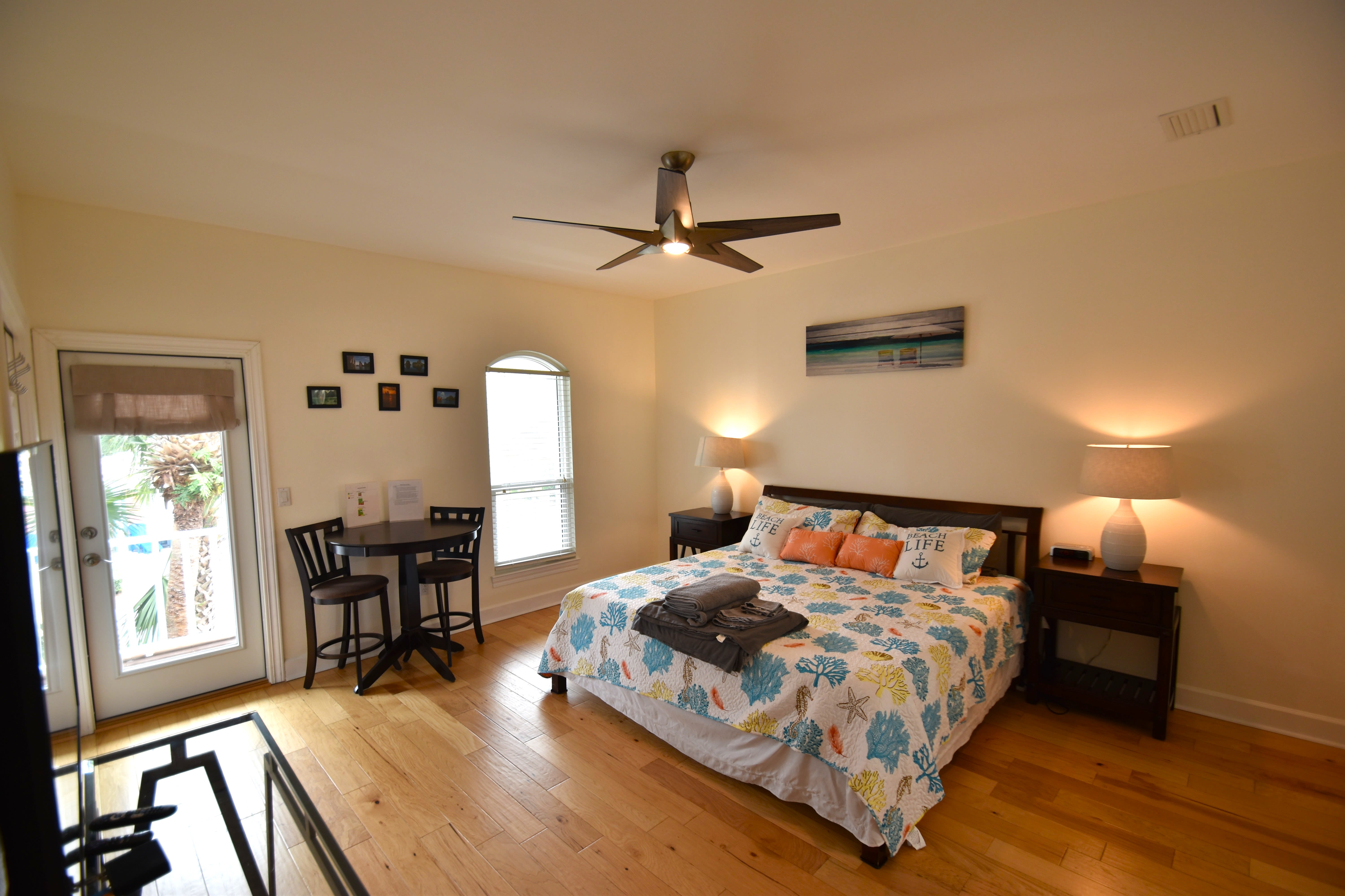 Bedroom 1 Master Suite with King bed bistro table and balcony access