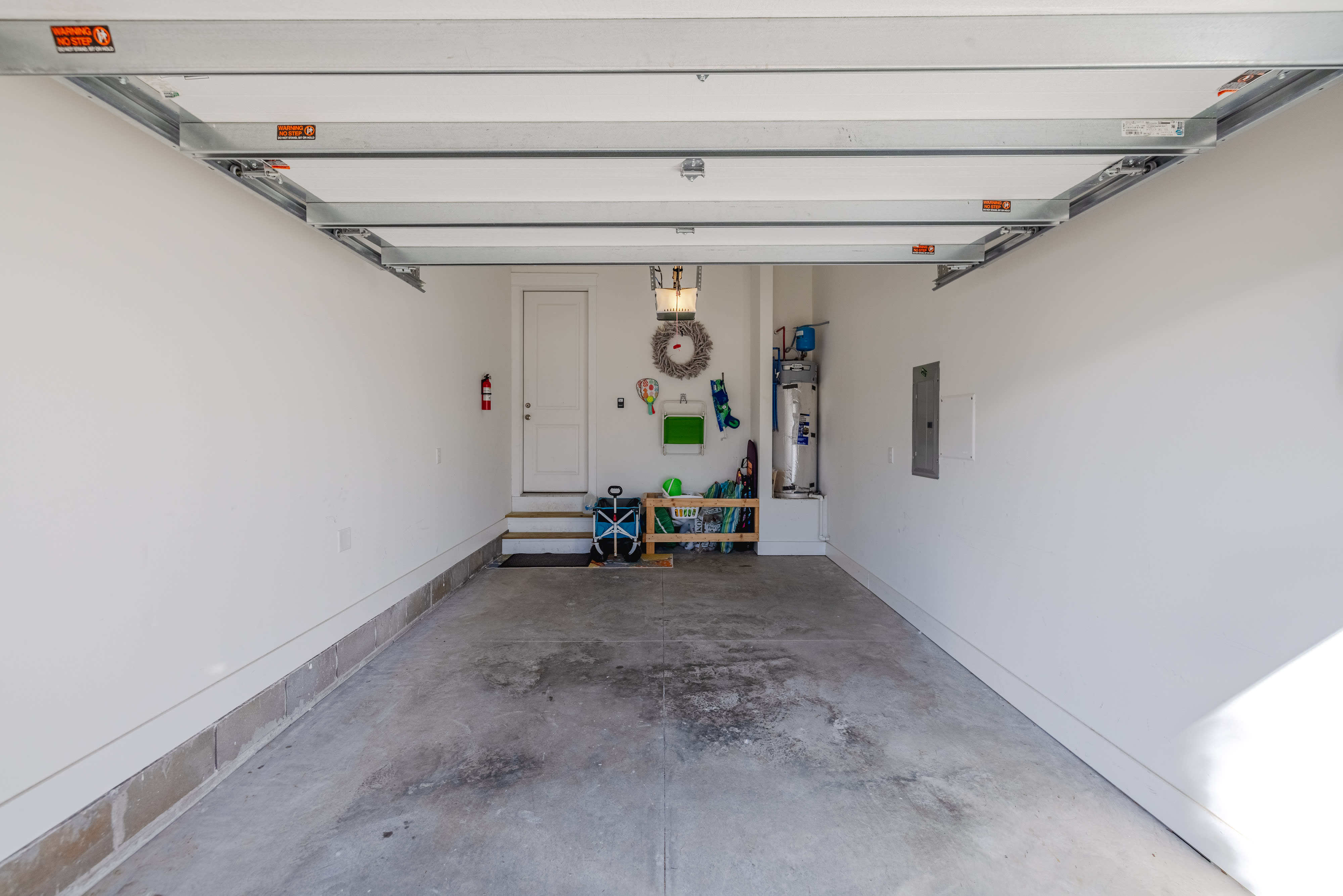 One car garage with beach chairs, utility cart, etc