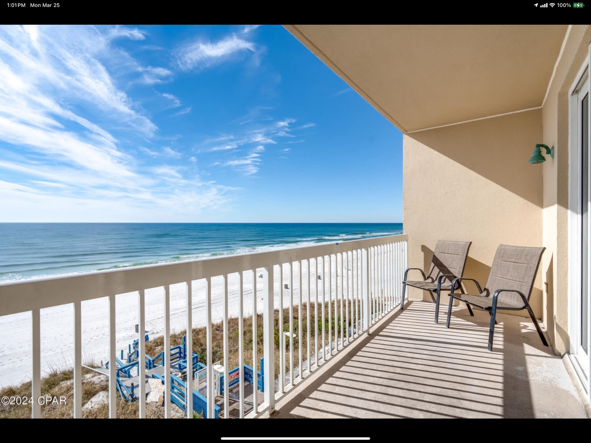 Private beachfront balcony with seating and sweeping views of turquoise Gulf waters