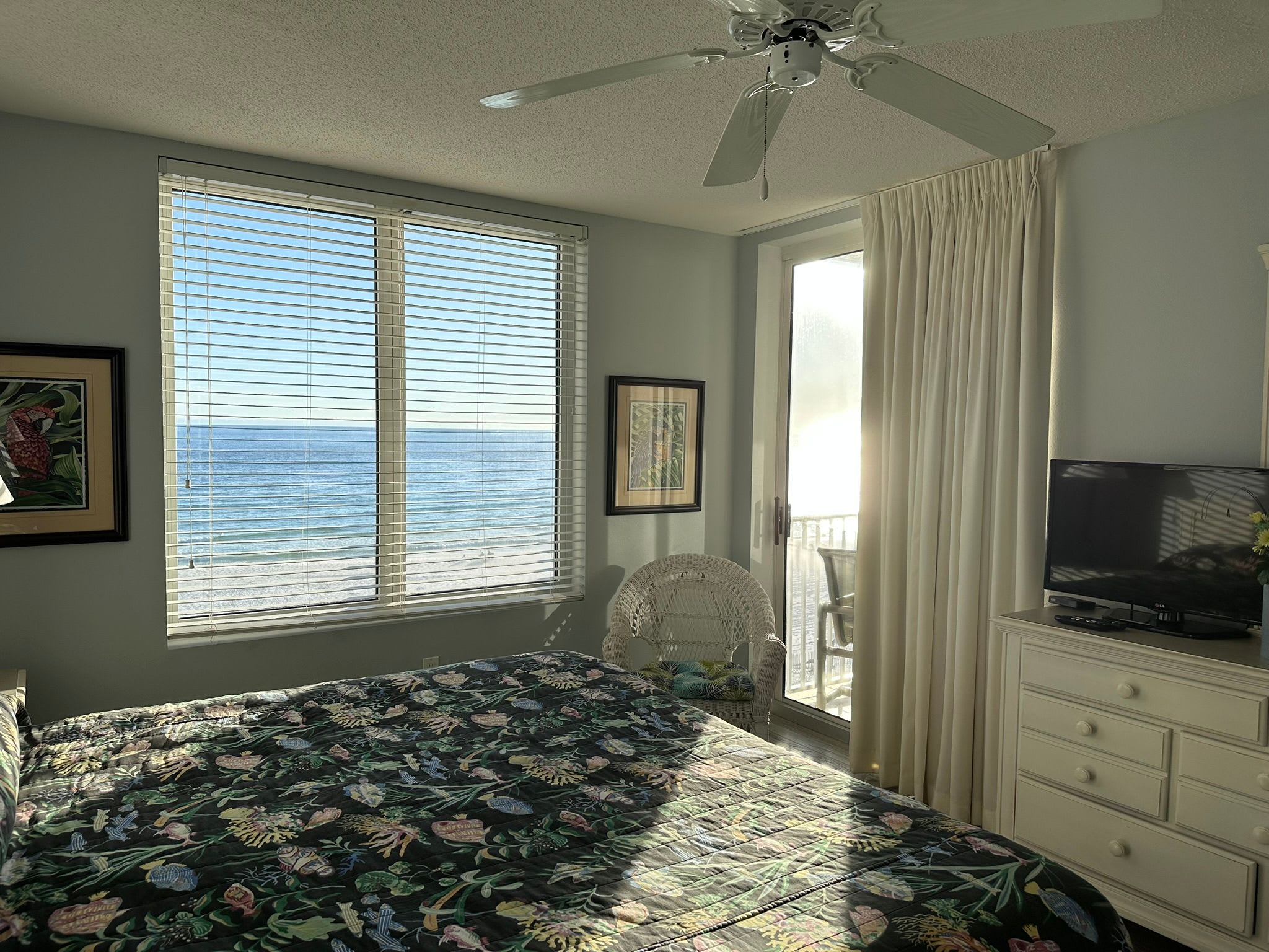 Master bedroom with king bed and private access to balcony.