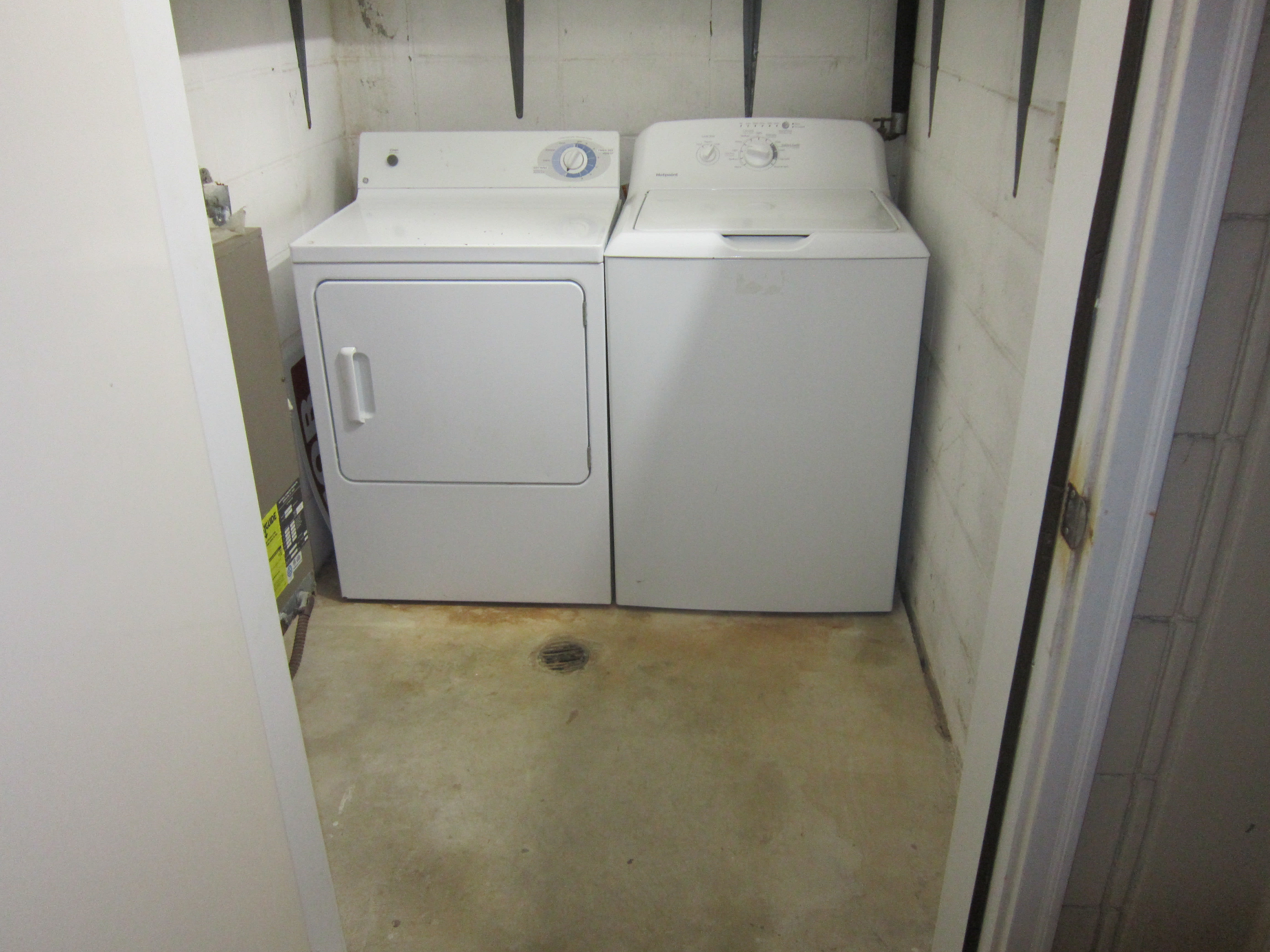 Storage room with lots of shelves and full sized washer and dryer.