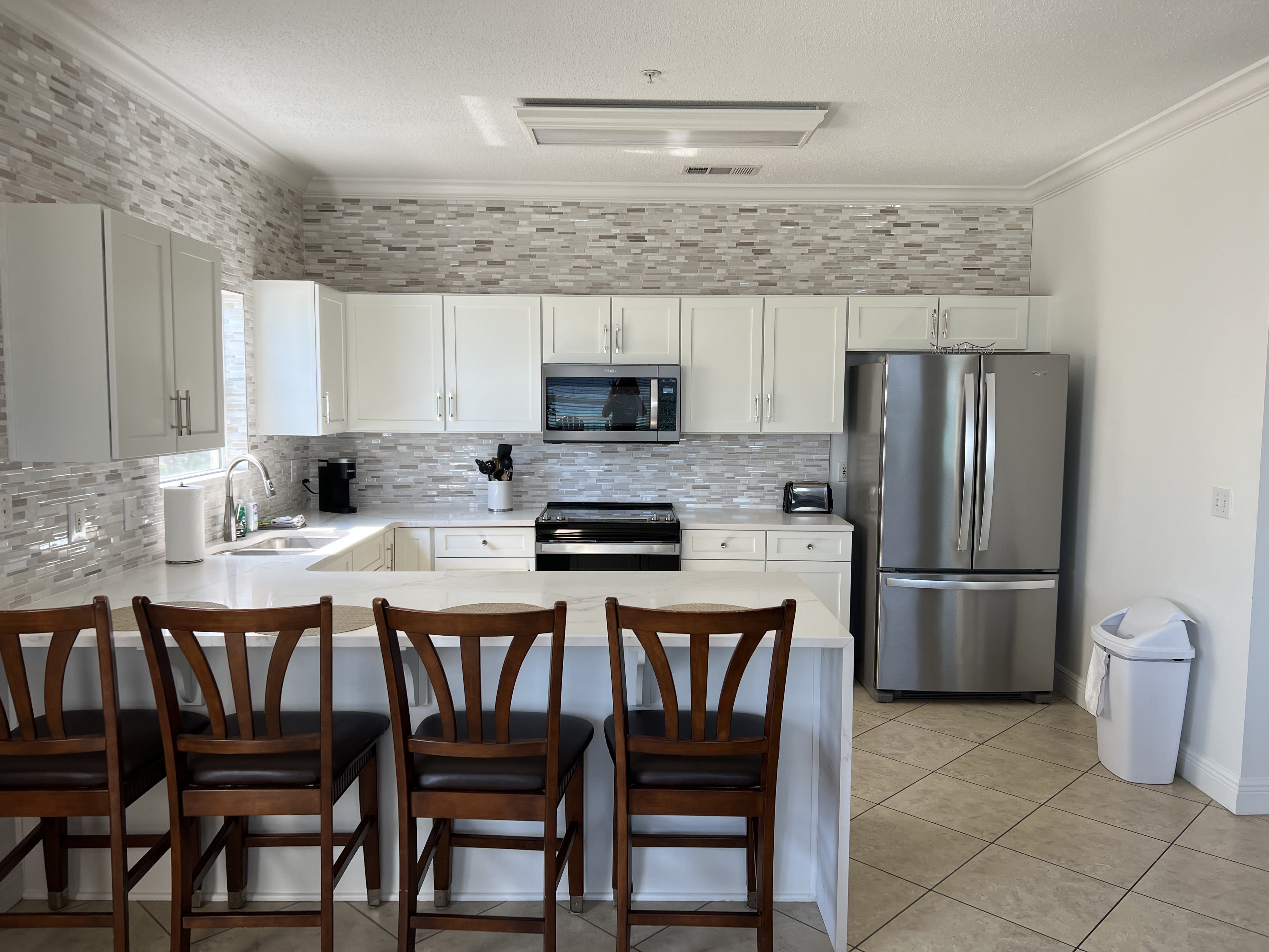 Newly renovated kitchen (showing old chairs)