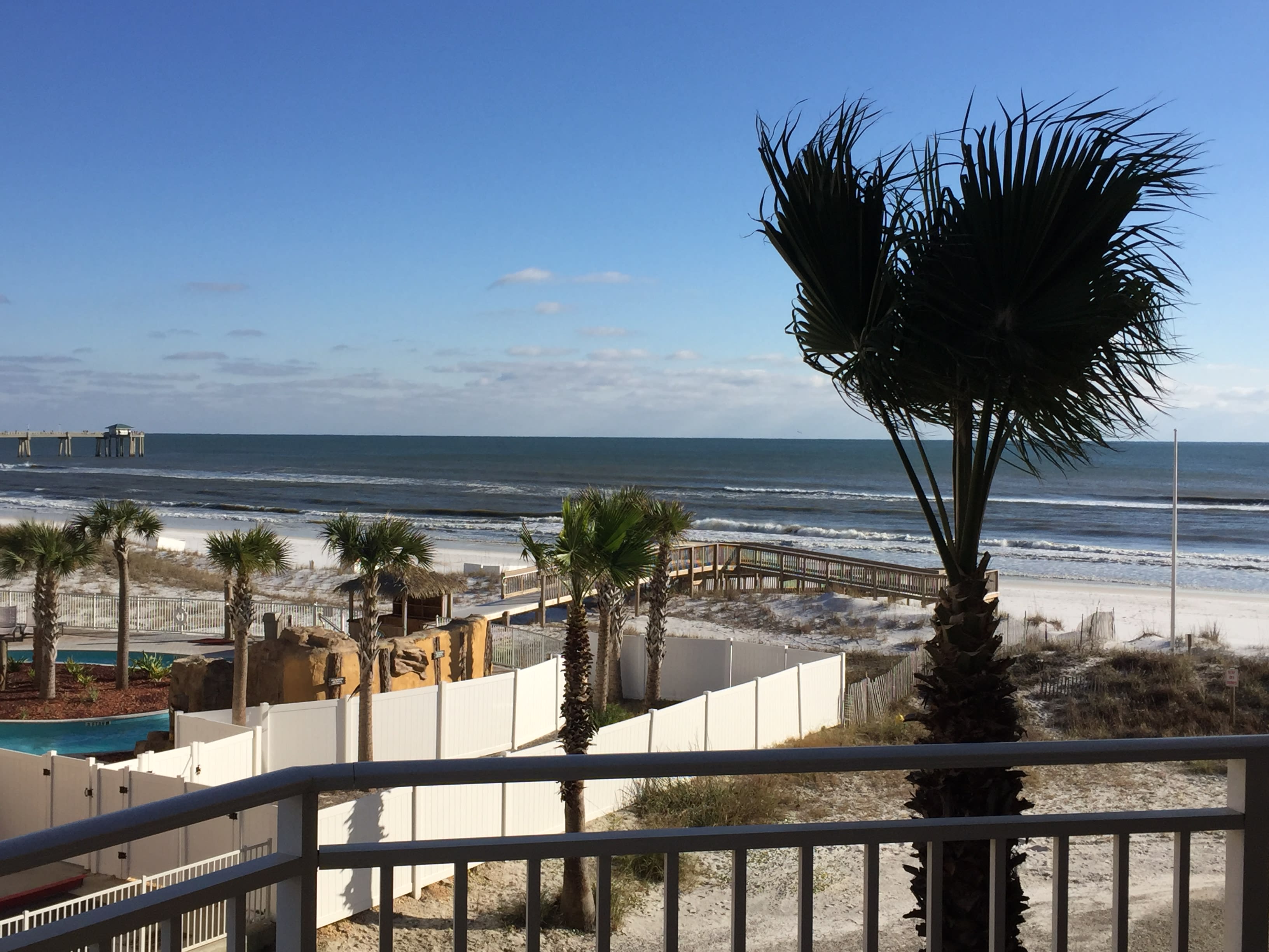 Views of Gulf from balcony; doors open fr suites and living area to balcony.