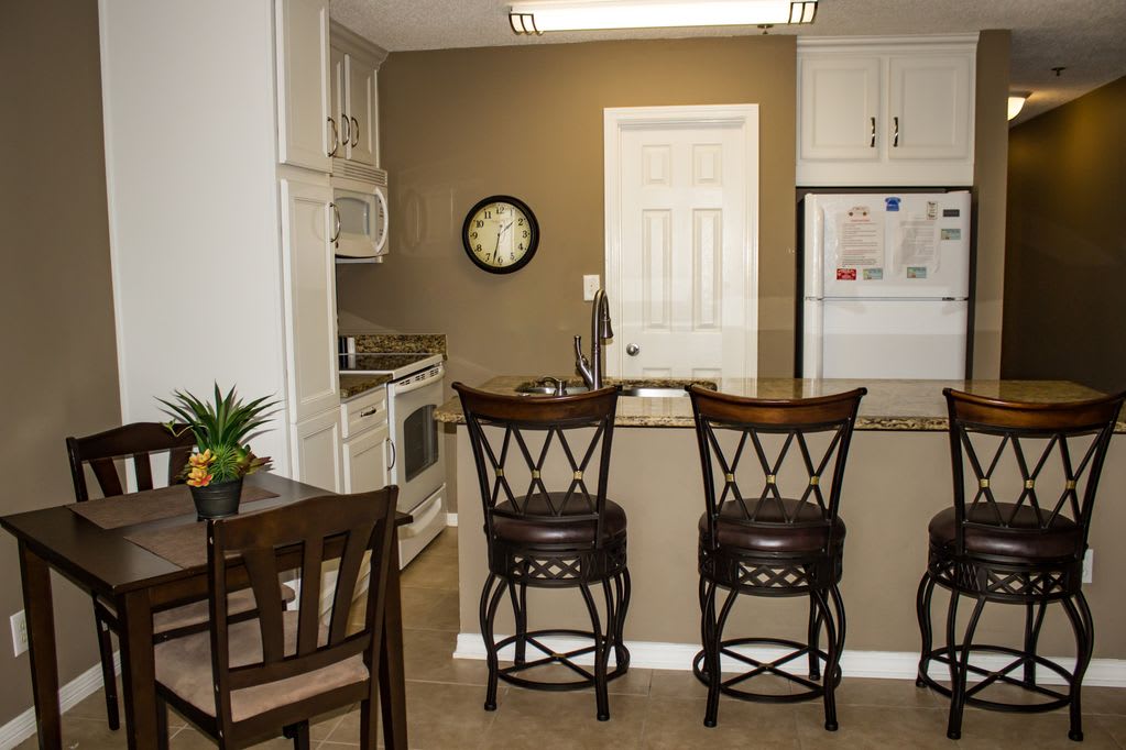 Updated kitchen cabinets,granite counter top, and bar stools, 