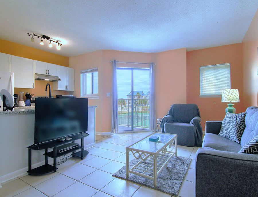 Living Room with Flat Screen TV and Kitchen