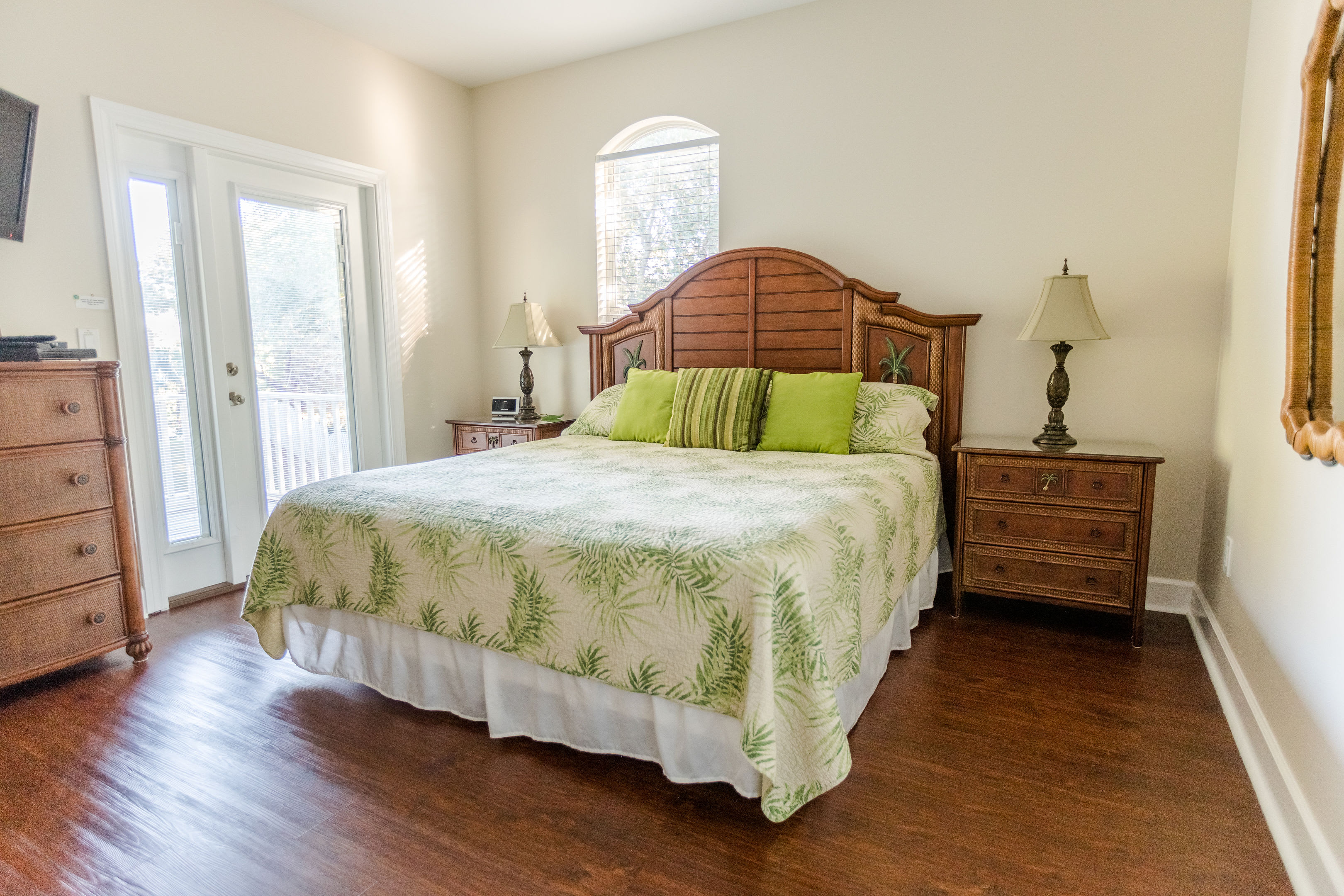 Second floor king bedroom with door to oversized porch overlooking huge yard