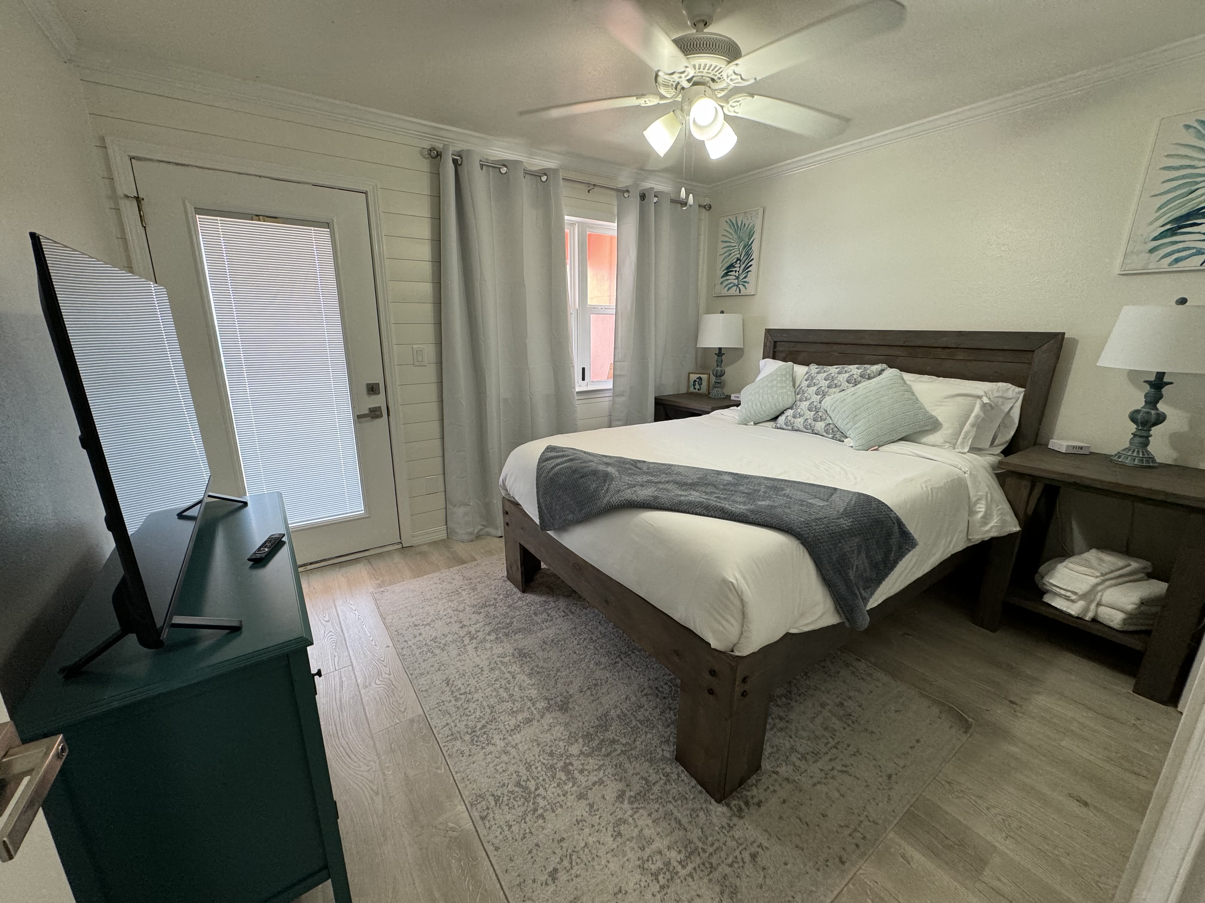 Queen bedroom with balcony access overlooking marina and ocean.