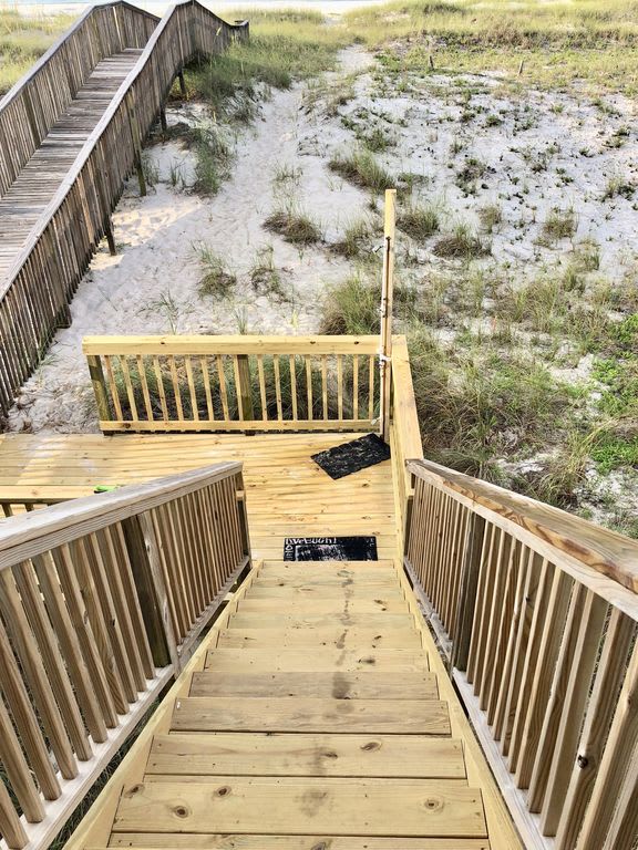 Stairs leading down to the beach with shower at bottom