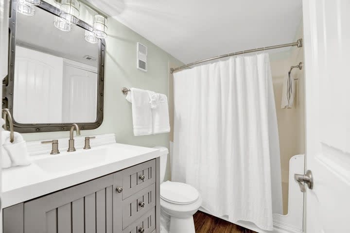 Guest/hall bathroom featuring step-in shower. Lots of drawers for toiletries.