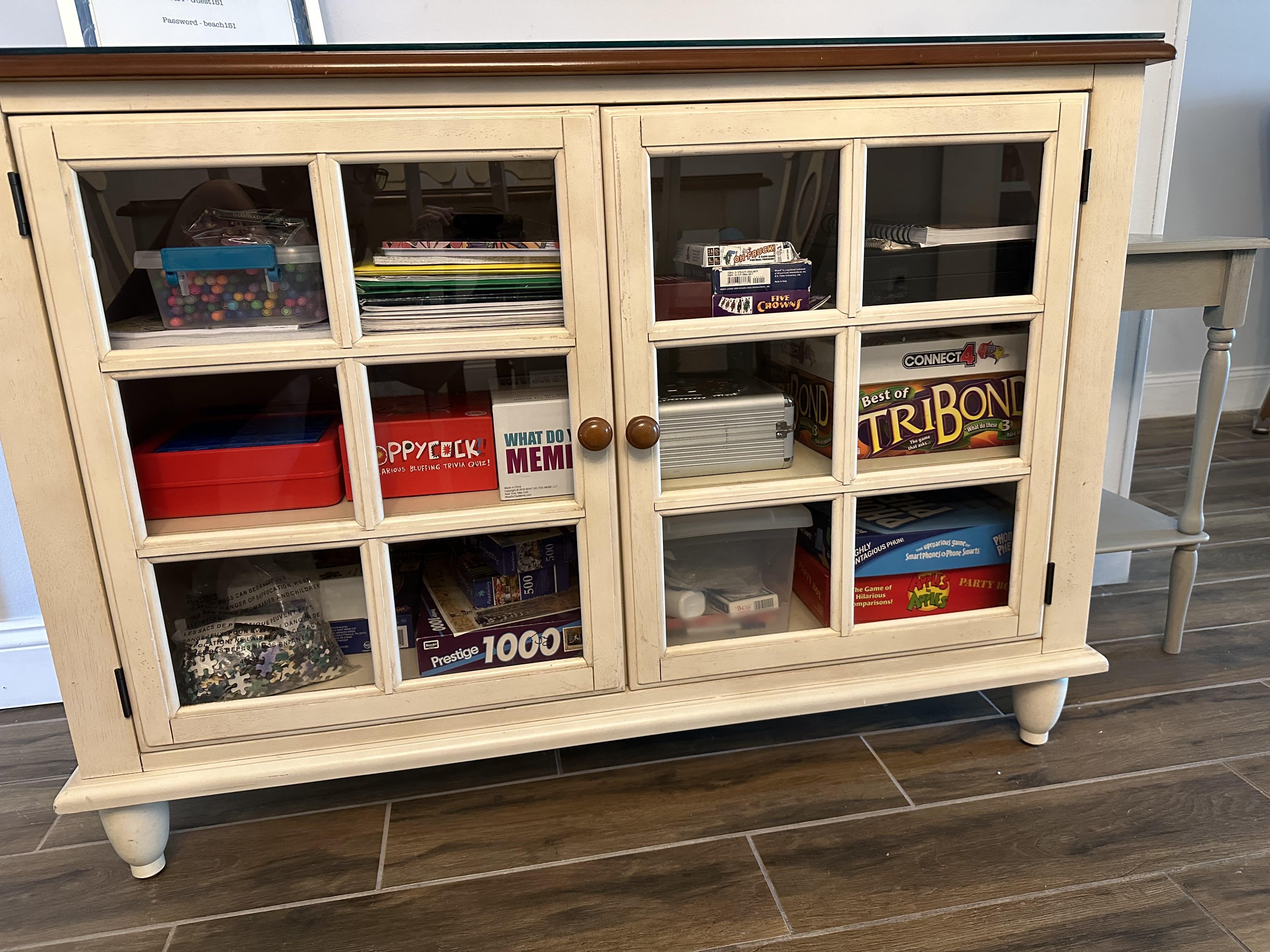 cabinet full of games/cards/puzzles and coloring activities