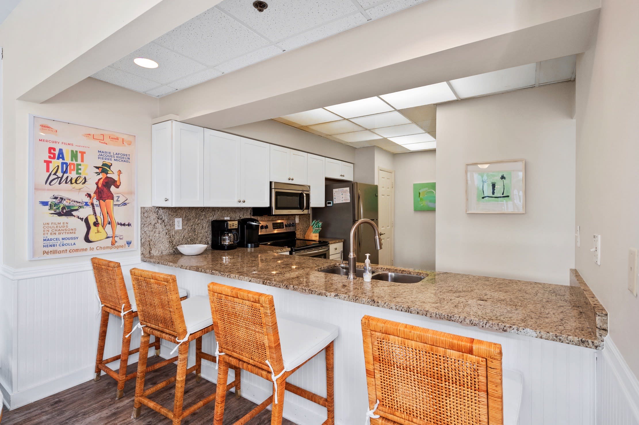 Bar area looks into the kitchen and seats 4.