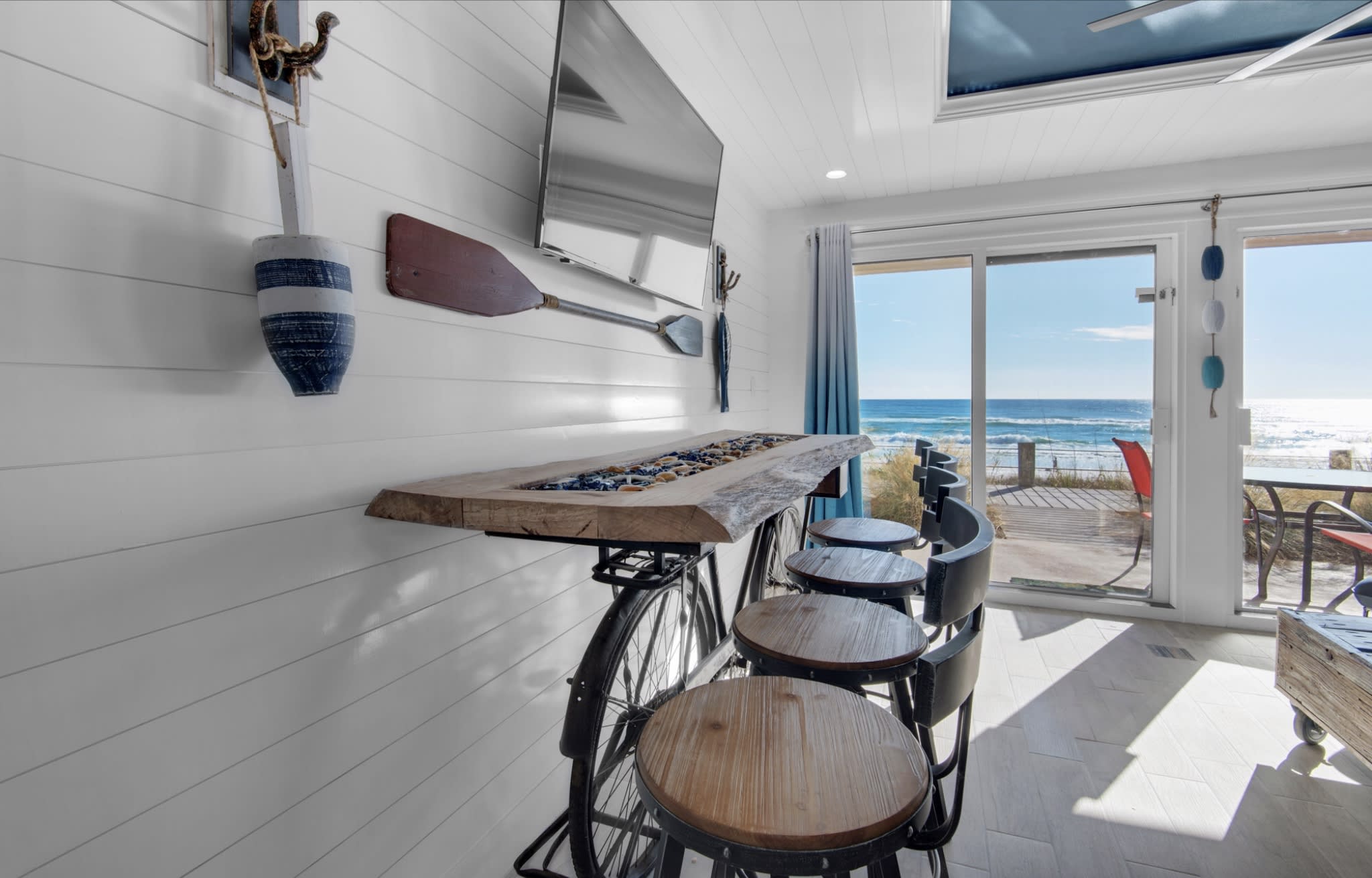 Custom made oak dining table over an antique bicycle &amp; shiplap walls