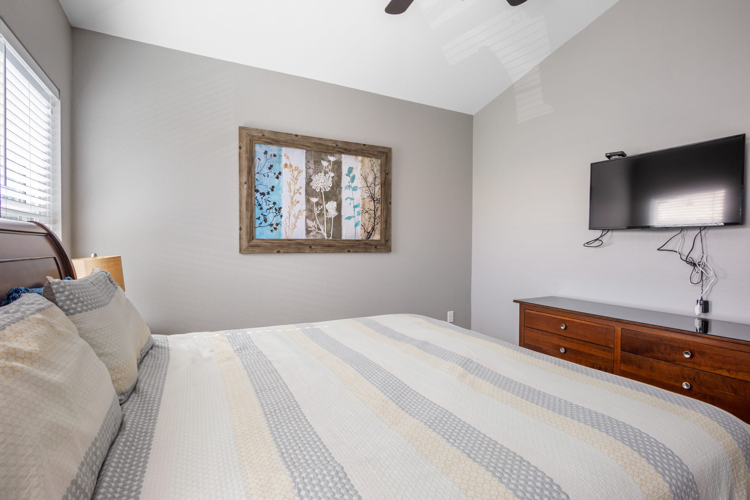 King suite has mounted flat screen tv and plenty of drawer space