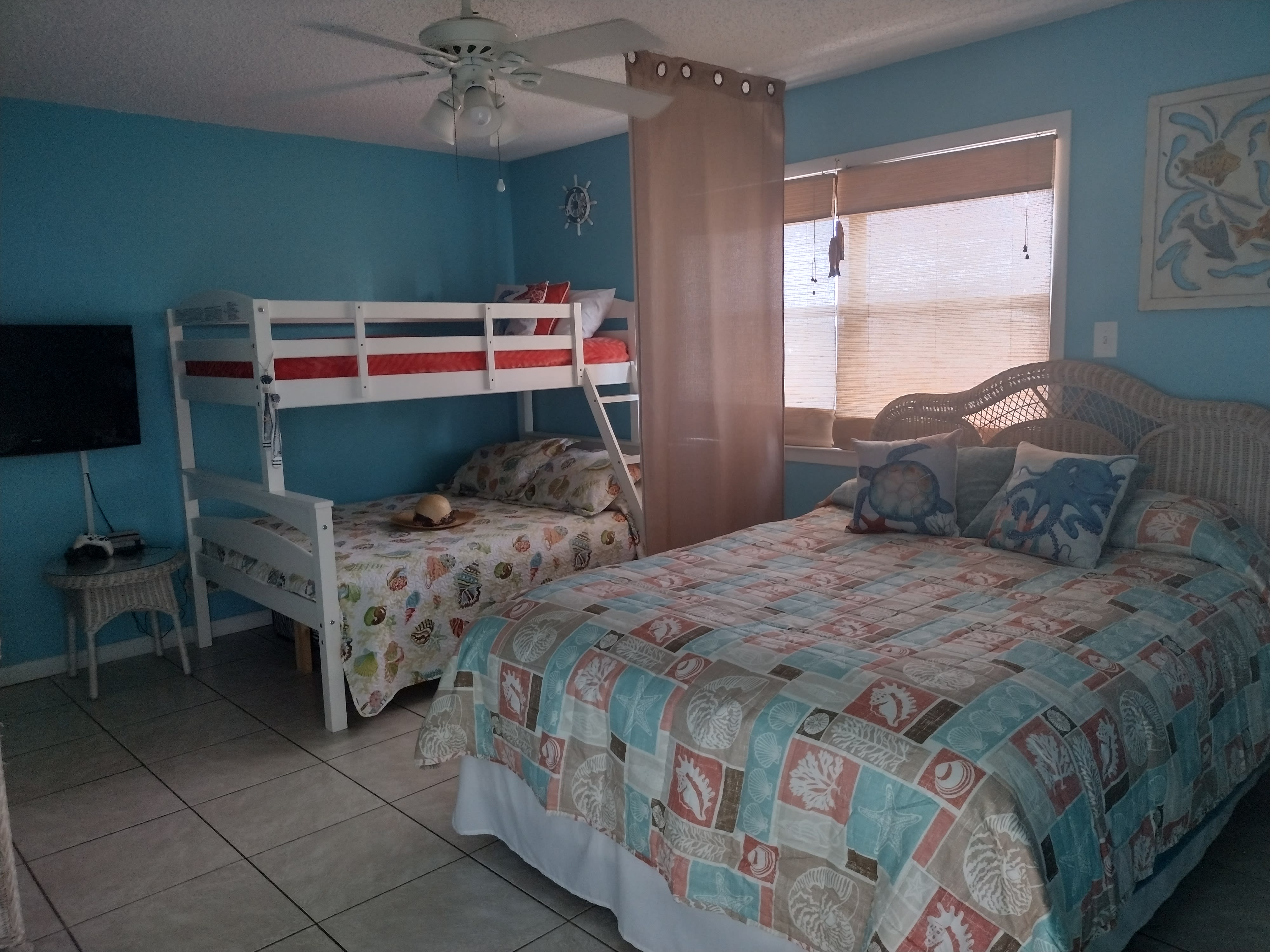 Bedroom with queen bed and bunkbed with lower full bed &amp; upper twin bed.