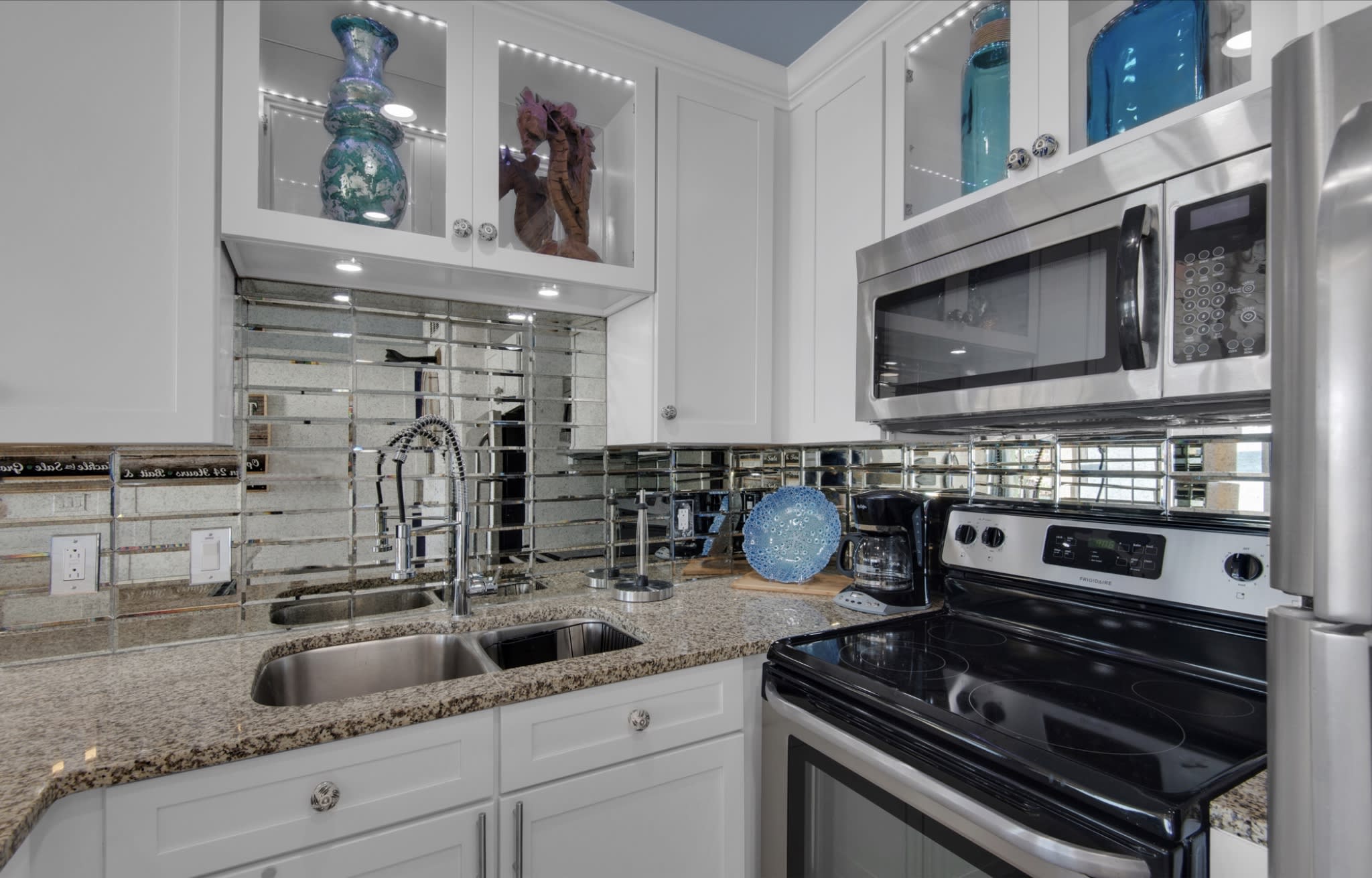 Smoked glass backsplash appointed with color changing LED lights 