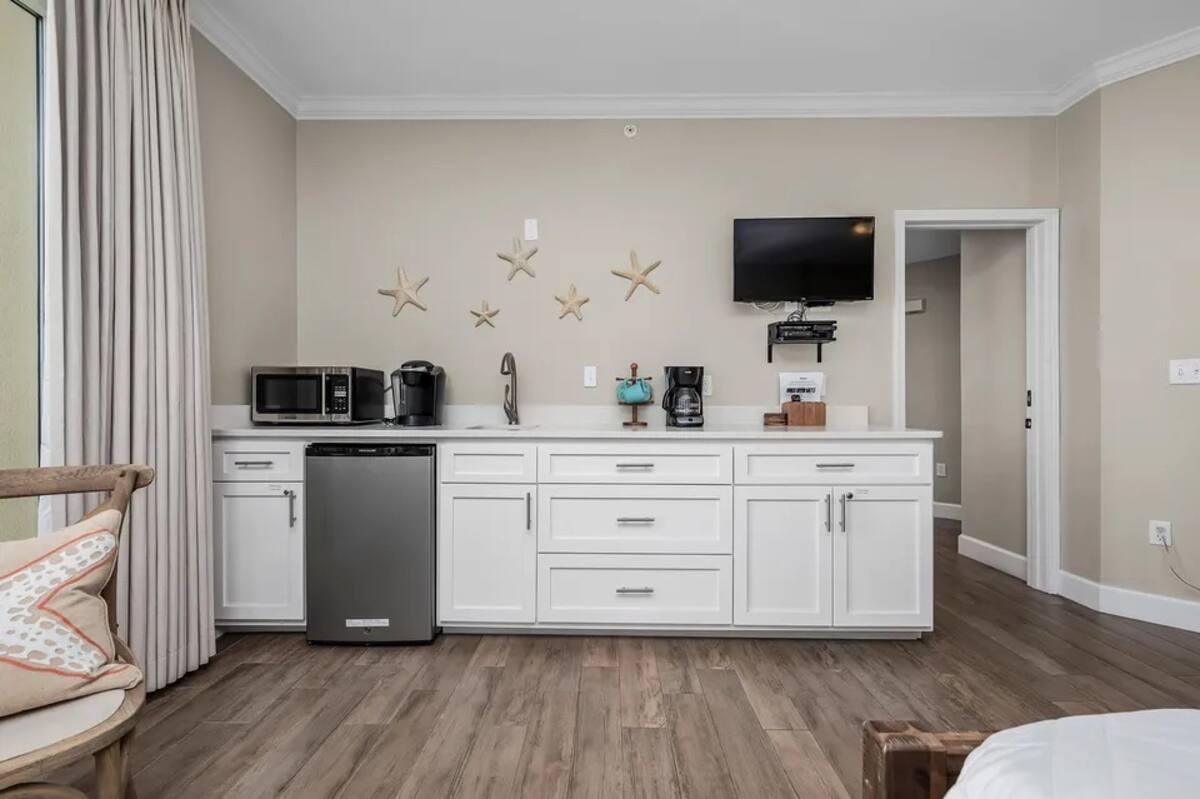 Kitchenette with mini-fridge, microwave, sink and quartz countertops