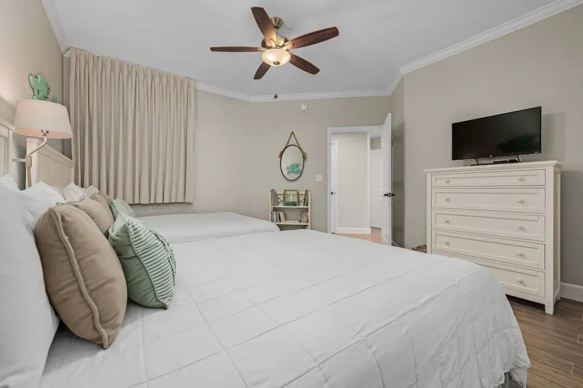 The second bedroom comfortably fits two queen beds and has private entry into the main bathroom