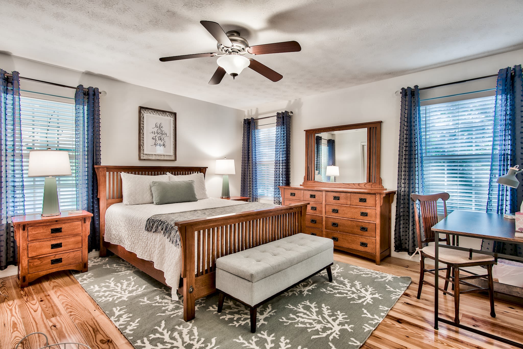 Master bedroom with a queen bed, large closet, workspace and ensuite.