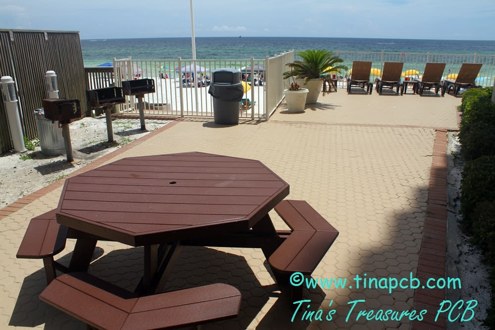 3 BBQ Grills on the pool deck on the beach with picnic tables
