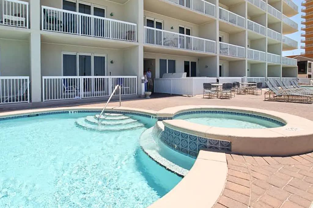 Oceanfront resort pool with loungers and sweeping views of the Gulf
