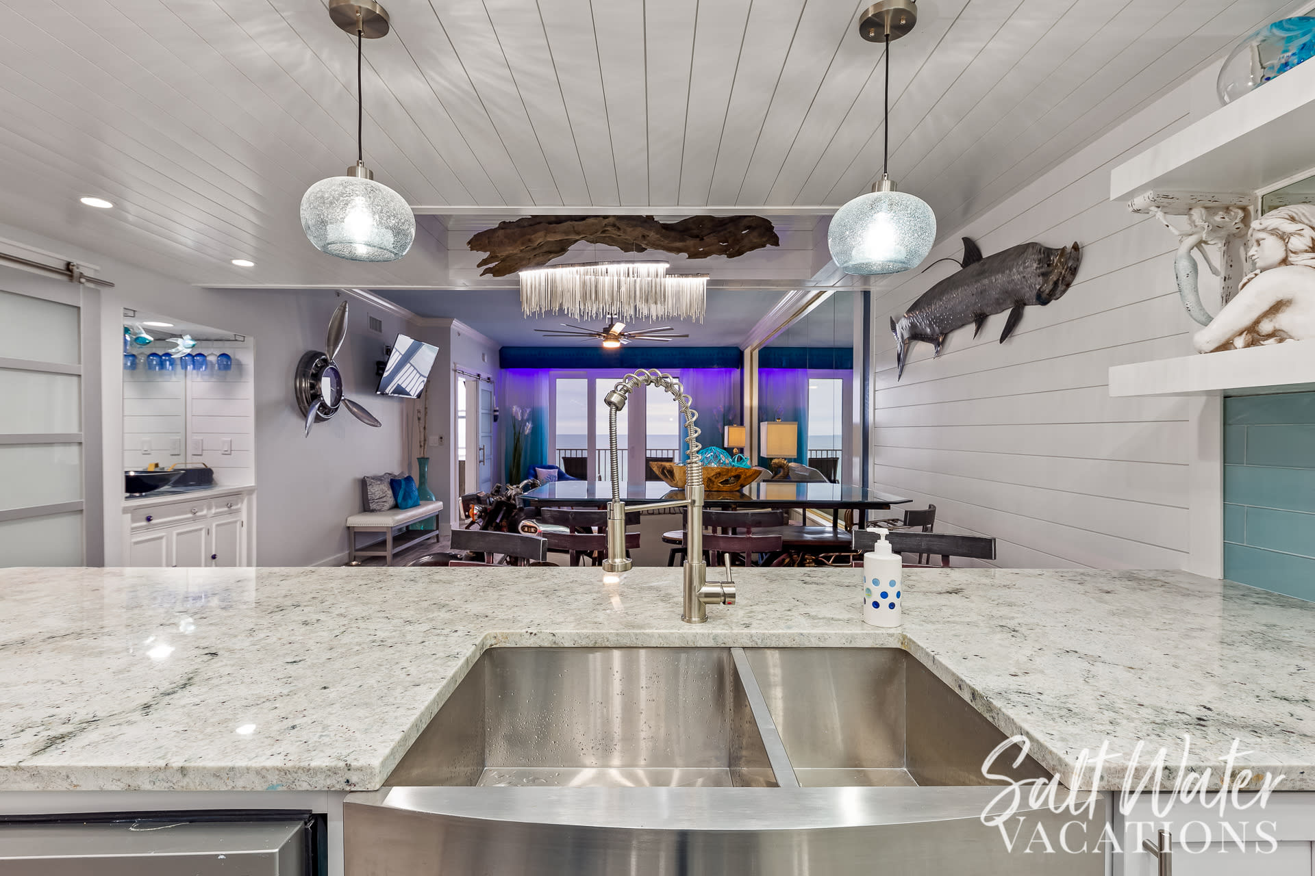 View looking from kitchen to gulf...wet bar on left, shiplap trimming 