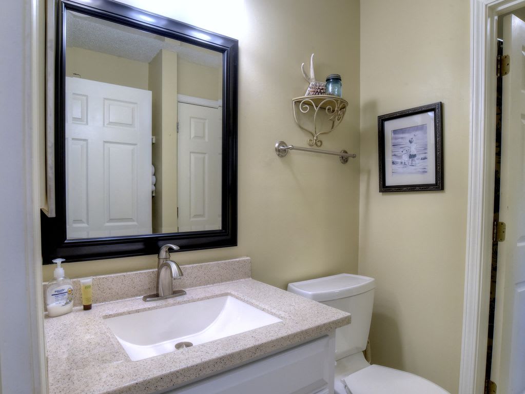 Hall half bath with separate entrance to shower/laundry room