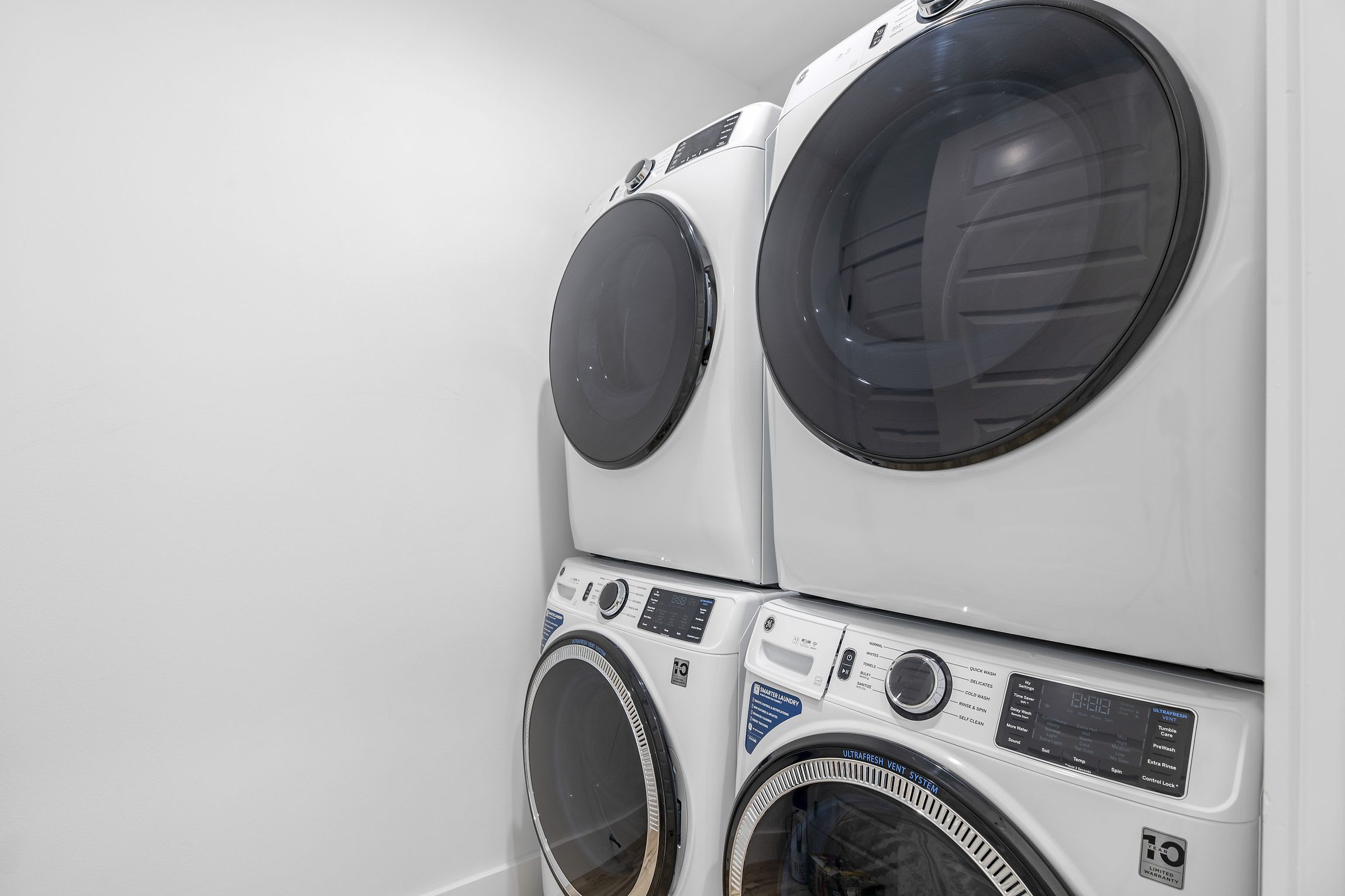 Laundry area with washers and dryers.