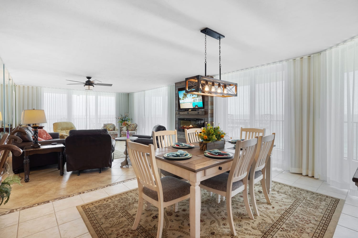 open area with dining and living, soft lighting with sheer drapes plus blackouts