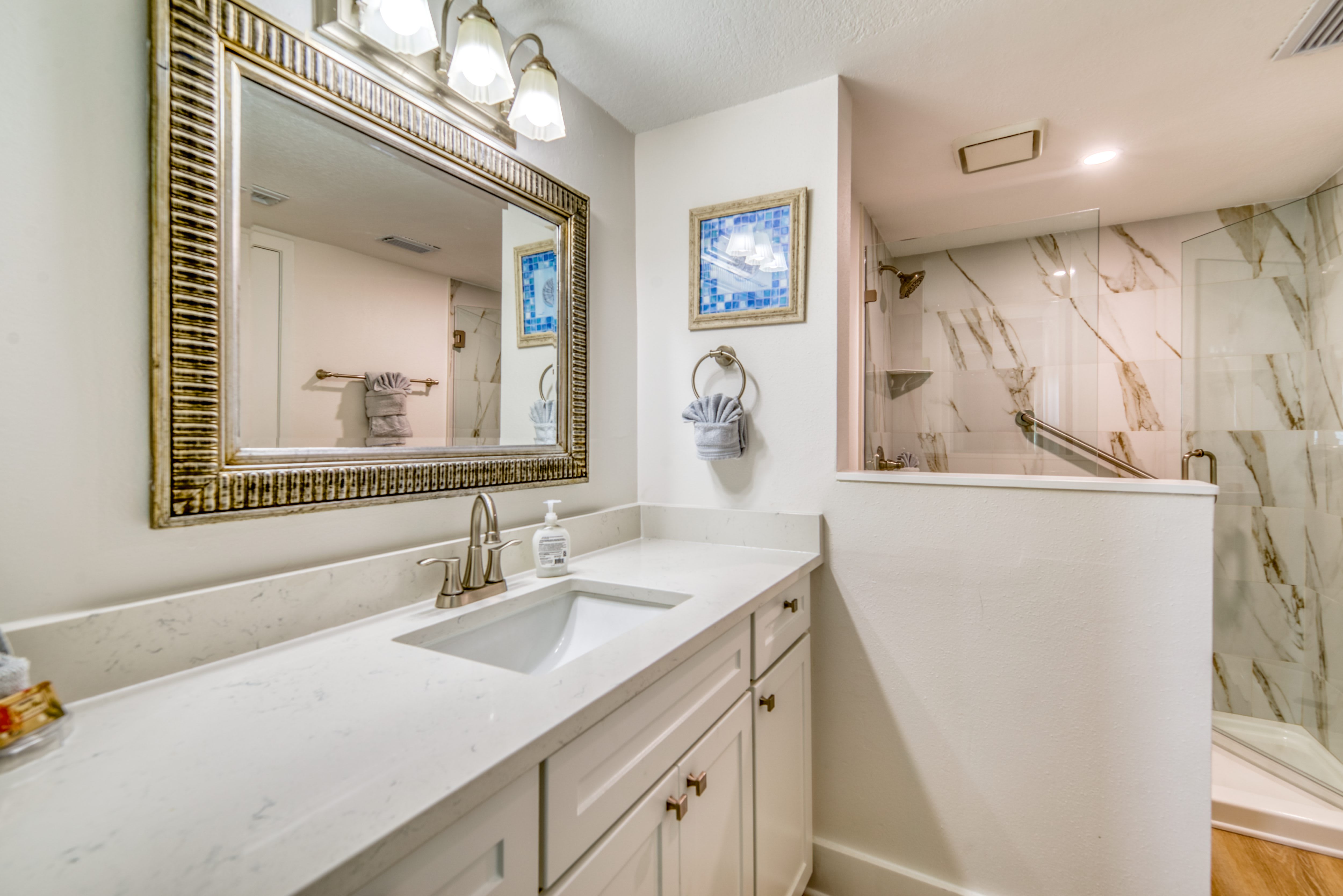 A clean and spacious bathroom with plenty of counter space.