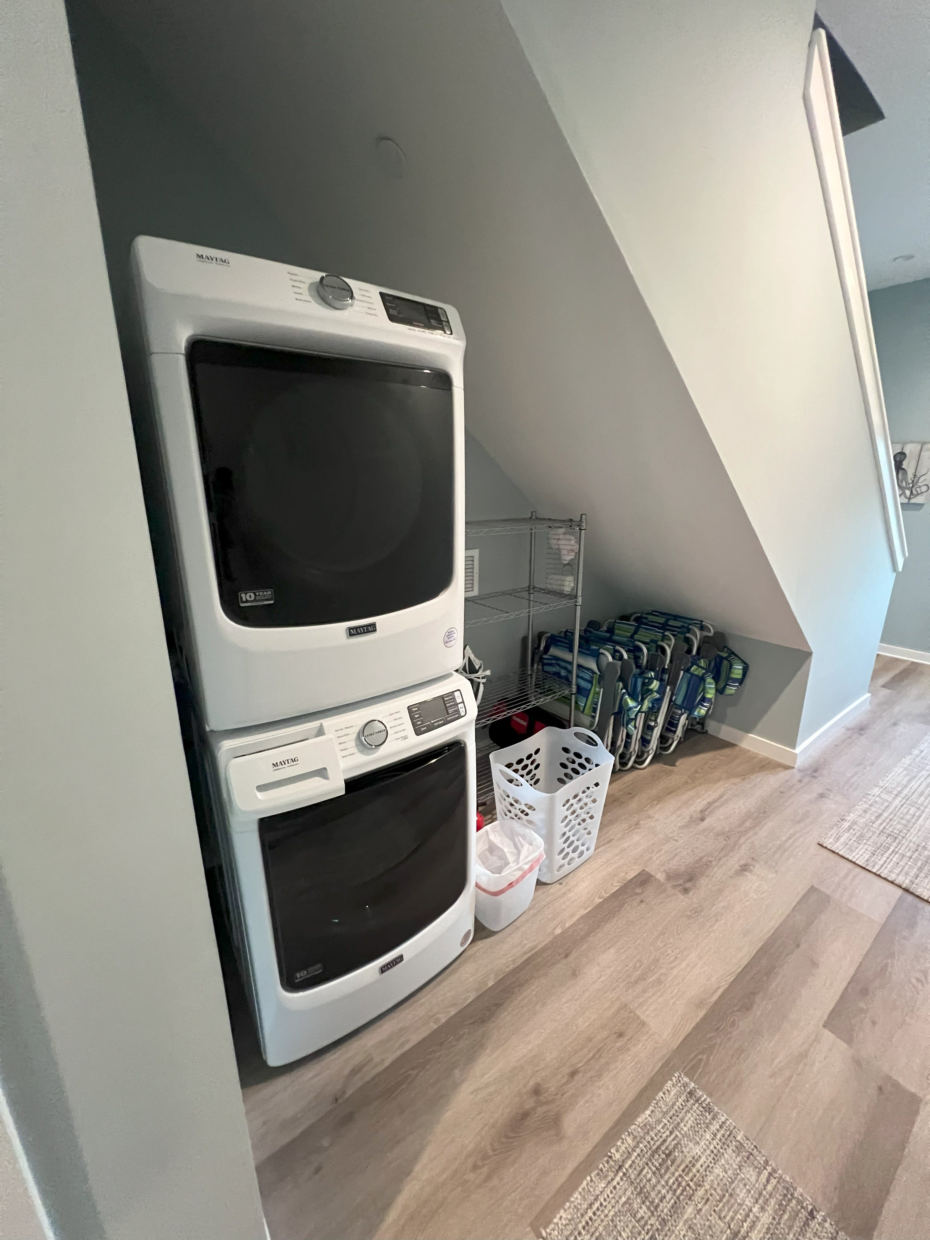 Washer, dryer, storage for beach gear, and chairs on bottom floor