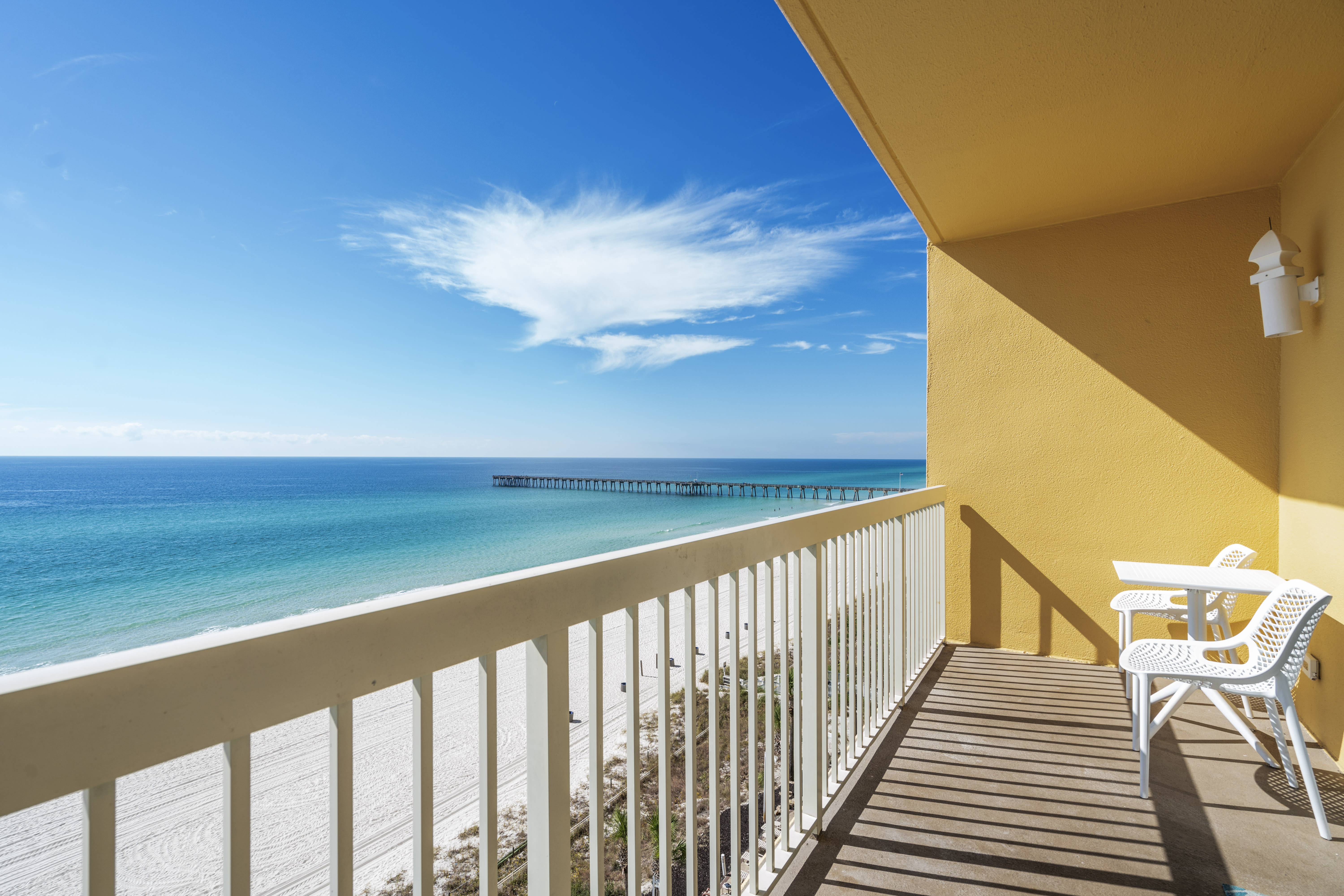 Gulf front balcony with 2 small tables and 4 chairs.